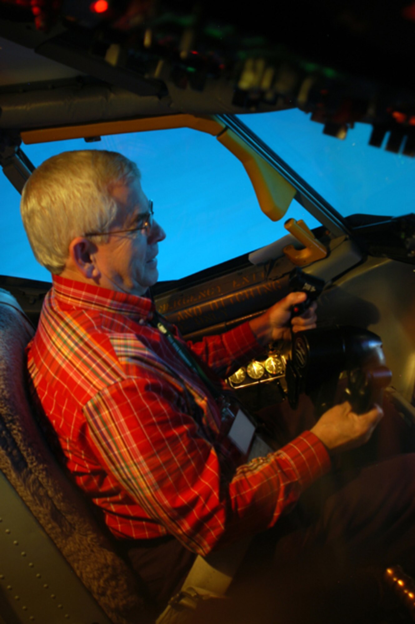 GRISSOM AIR RESERVE BASE, Ind. --  Hal Job, a member of the Grissom Community Council, banks a KC-135R Stratotanker hard right in a flight simulator here Nov. 4. Mr. Job and his wife Rosemary attended a GCC meeting hosted by the 434th Operations Support Squadron that allowed council members to take their turn at the stick in the simulator. The meeting also included displays of life support equipment and a special briefing.  (U.S. Air Force photo/Senior Airman Mark Orders-Woempner)