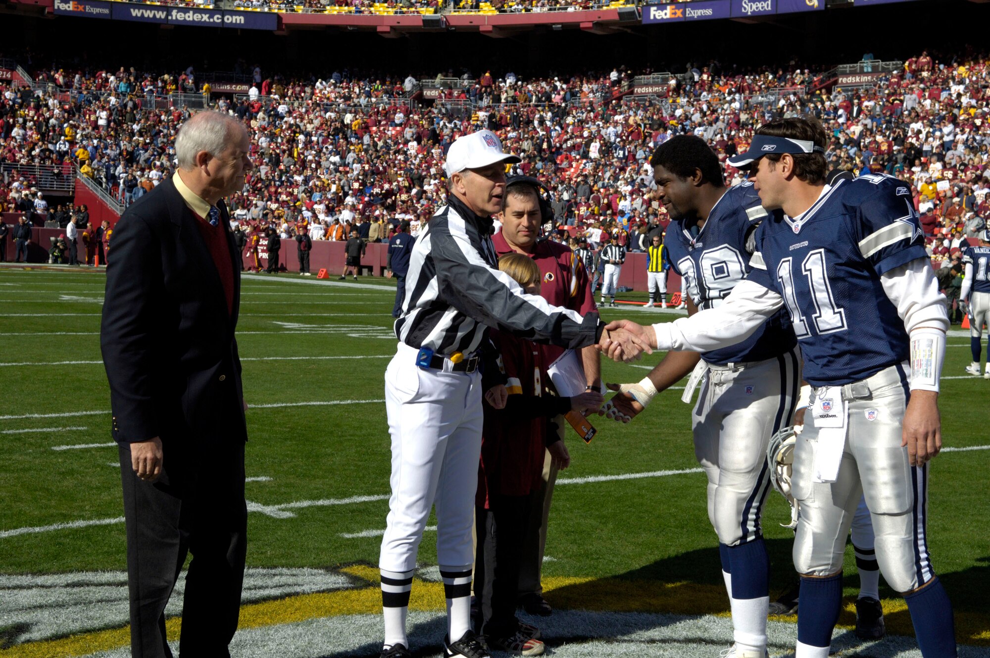 Secretary of the Air Force Michael W. Wynne officiates the coin toss for the National League Football game between the Washington Redskins and the Dallas Cowboys at FedEx Field in Landover, Md. on Nov. 5.  This was just one of several activities that took place during Air Force Appreciation Day there.  (U.S. Air Force photo/Tech. Sgt. Cohen Young)