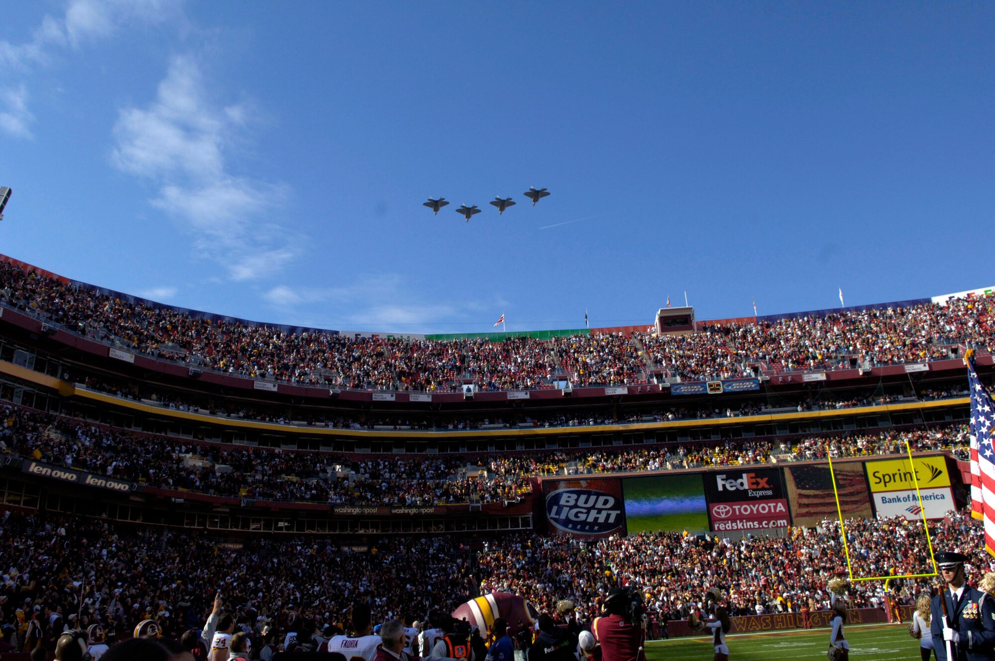 Four F-22 Raptors from the 1st Fighter Wing at Langley Air Force Base, Va., fly over FedEx Field in Landover, Md. on Nov. 5 as Secretary of the Air Force Michael W. Wynne officiates the coin toss for the Washington Redskins vs. Dallas Cowboys football game.  The flyover was just one of several activities that took place during Air Force Appreciation Day there. (U.S. Air Force photo/Tech. Sgt. Cohen Young)