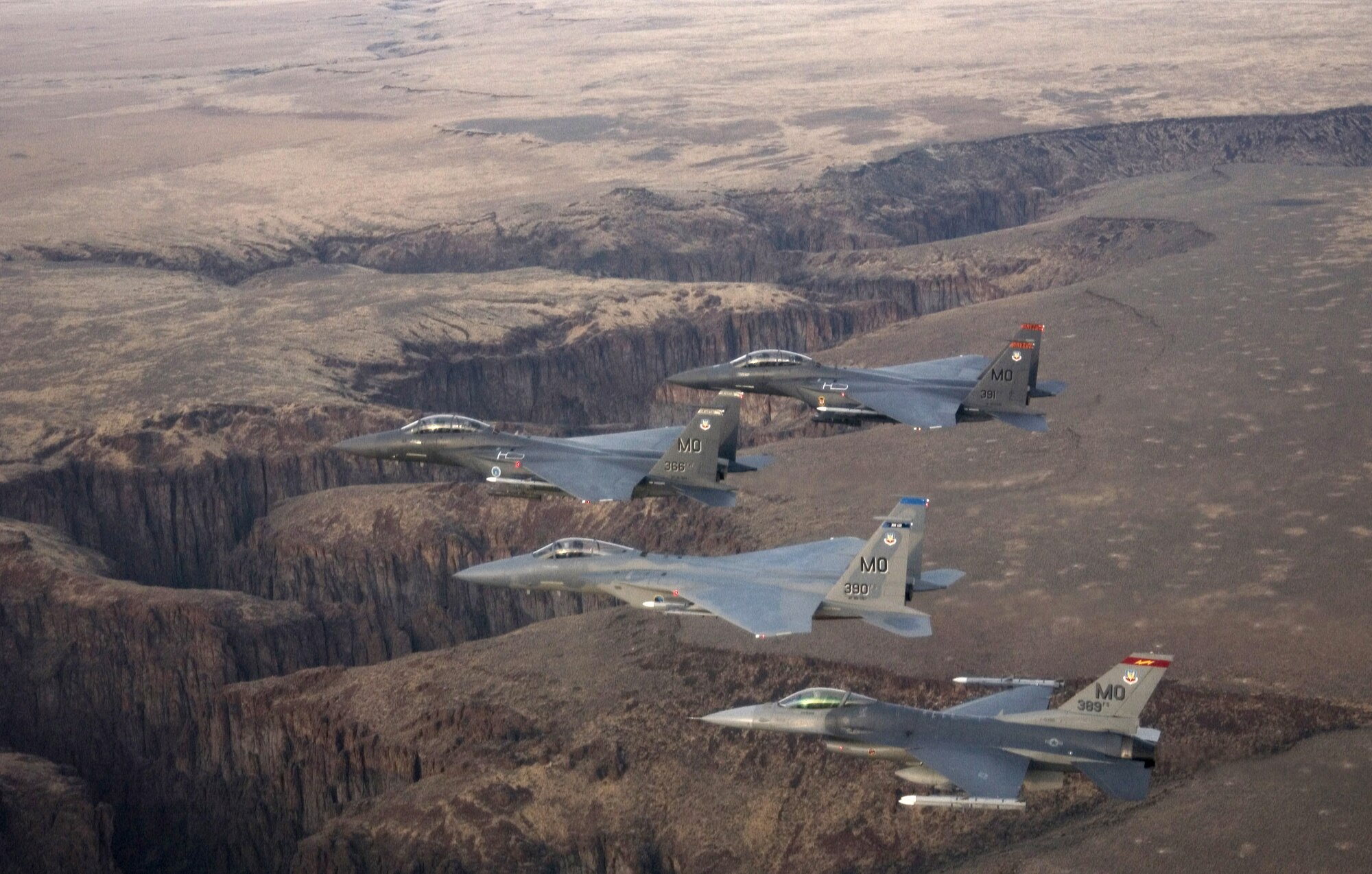 A four-ship formation flies out to the Idaho training ranges Nov. 1. Col. Anthony Rock, 366th Fighter Wing commander, led the formation of two F-15 Strike Eagles, an F-15 Eagle and an F-16 Fighting Falcon from the 366th FW at Mountain Home Air Force Base, Idaho. The 366th FW began the first phase of its F-16 Fighting Falcon drawdown when five jets departed the base Nov. 2. The departure is part of the wing's realignment. (U.S. Air Force photo/Master Sgt. Kevin J. Gruenwald)