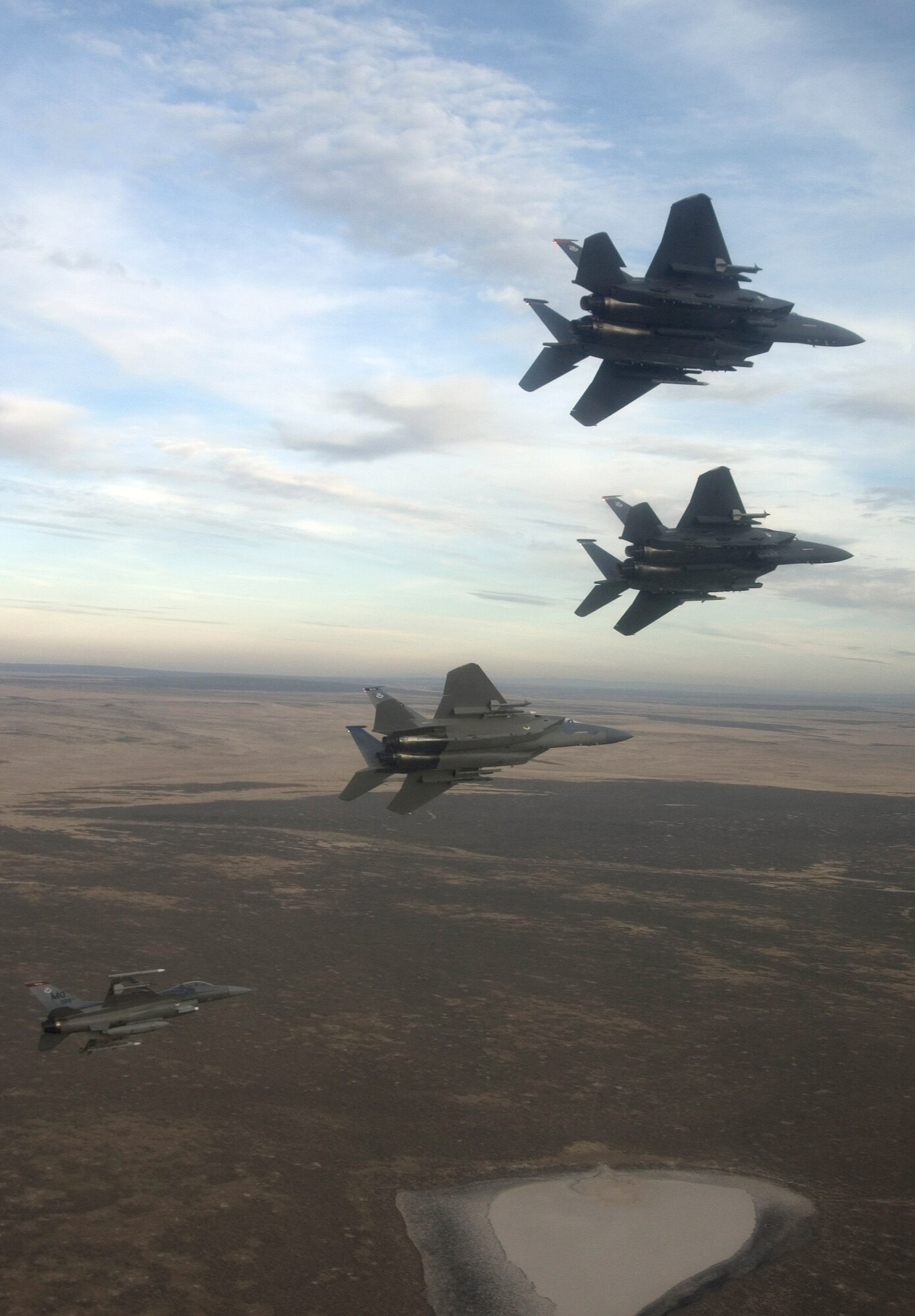 A four-ship formation flies out to the Idaho training ranges Nov. 1. Col. Anthony Rock, 366th Fighter Wing commander, led the formation of two F-15 Strike Eagles, an F-15 Eagle and an F-16 Fighting Falcon from the 366th FW at Mountain Home Air Force Base, Idaho. The 366th FW began the first phase of its F-16 Fighting Falcon drawdown when five jets departed the base Nov. 2. The departure is part of the wing's realignment. (U.S. Air Force photo/Master Sgt. Kevin J. Gruenwald) 
