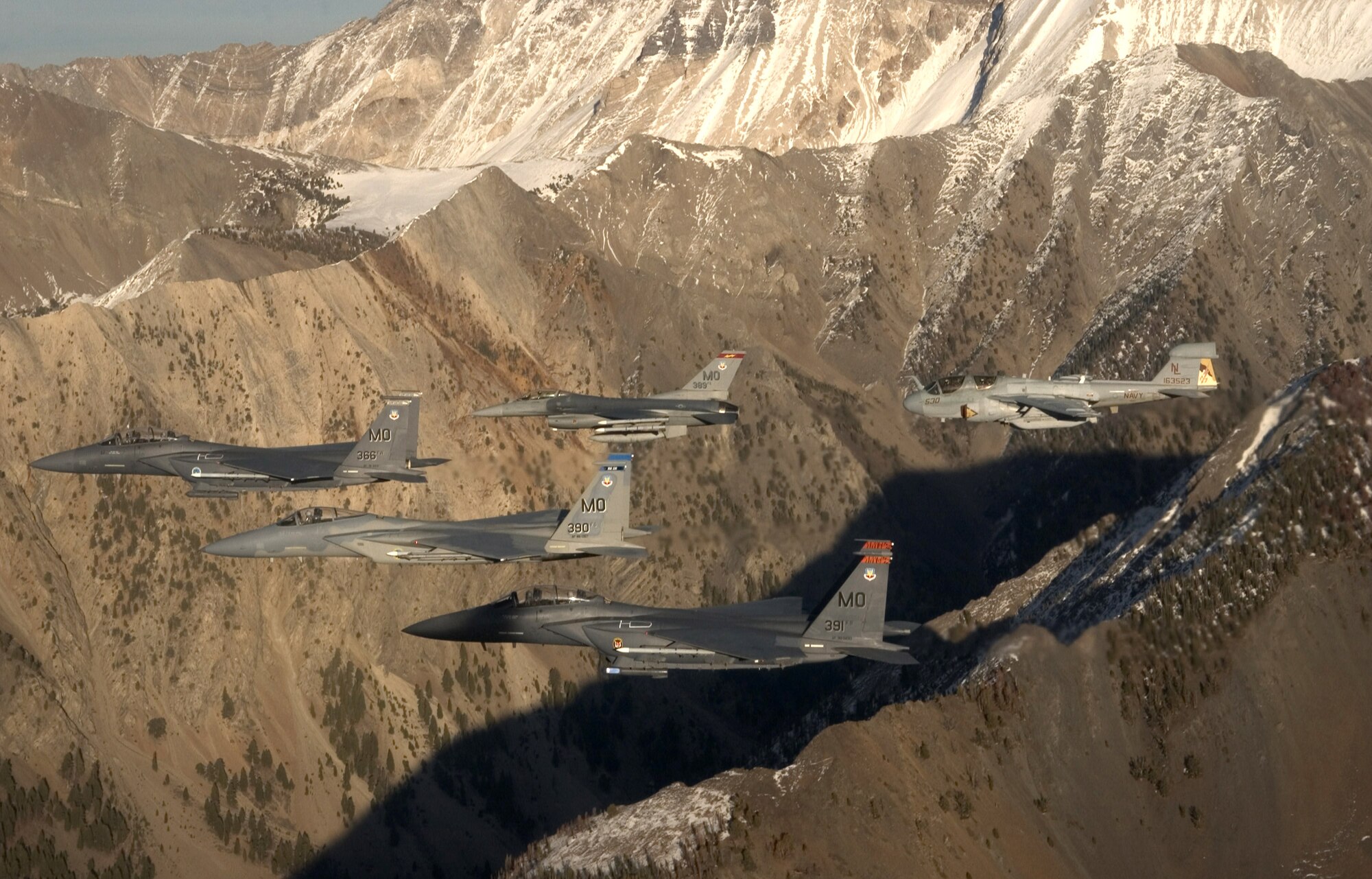 A five-ship formation flies over the Idaho Sawtooth Mountains Nov. 1. Col. Anthony Rock, 366th Fighter Wing commander, led the formation of two F-15E Strike Eagles, and F-15 Eagle, an F-16 Fighting Falcon, all from the 366th FW at Mountain Home Air Force Base, Idaho, and an EA-6B Prowler from the 388th Electronic Control Squadron at Naval Air Station Whidbey Island, Wash. The 366th FW began the first phase of its F-16 drawdown when five jets departed the base Nov. 2. The departure is part of the wing's realignment. (U.S. Air Force photo/Master Sgt. Kevin J. Gruenwald)