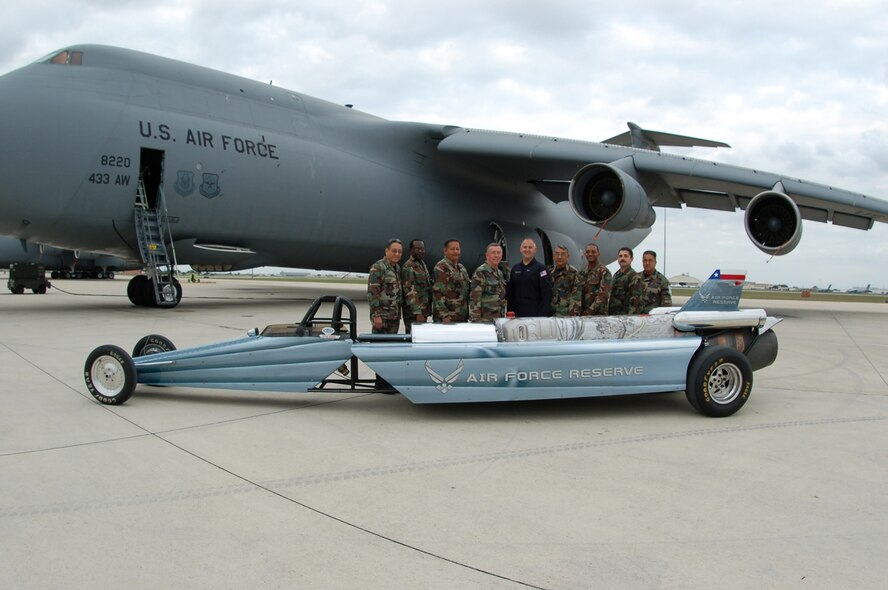 Sponsored by the Air Force Reserve, Bill Braak, a former Reserve C-141 flight engineer turned driver, appeared at the Lackland AFB Airfest 2006, november 4-5, with his Air Force Reserve Rocket car. The car utilizes a Westinghouse J34-48. Originally used in the North American Buckeye T-2A aircraft. Bill, center is surrounded by the members of the 433rd Maintenance Group sheetmetal shop. The Reservists helped get the car back into action after the first day of performances caused a couple of small tears in the metal bands reenforcing the canister in the aft section of the car.