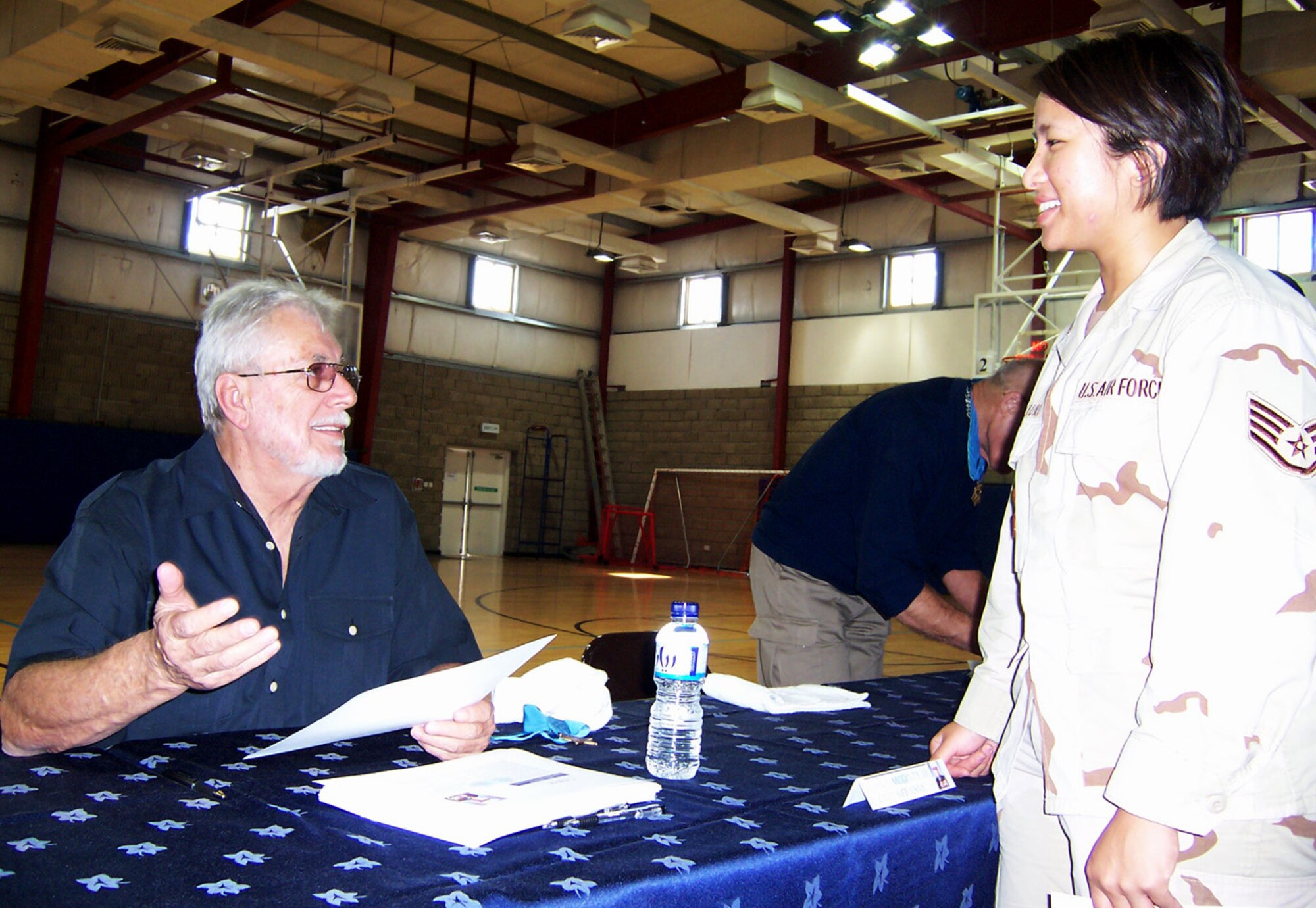 Staff Sgt. Shafinah Rosauro, 379th Expeditionary Contracting Squadron, chats with Medal of Honor recipient Marine Capt. John McGinty III during an assembly Nov. 3 at a base in Southwest Asia. (U.S. Air Force photo/Tech. Sgt. Steve Staedler)