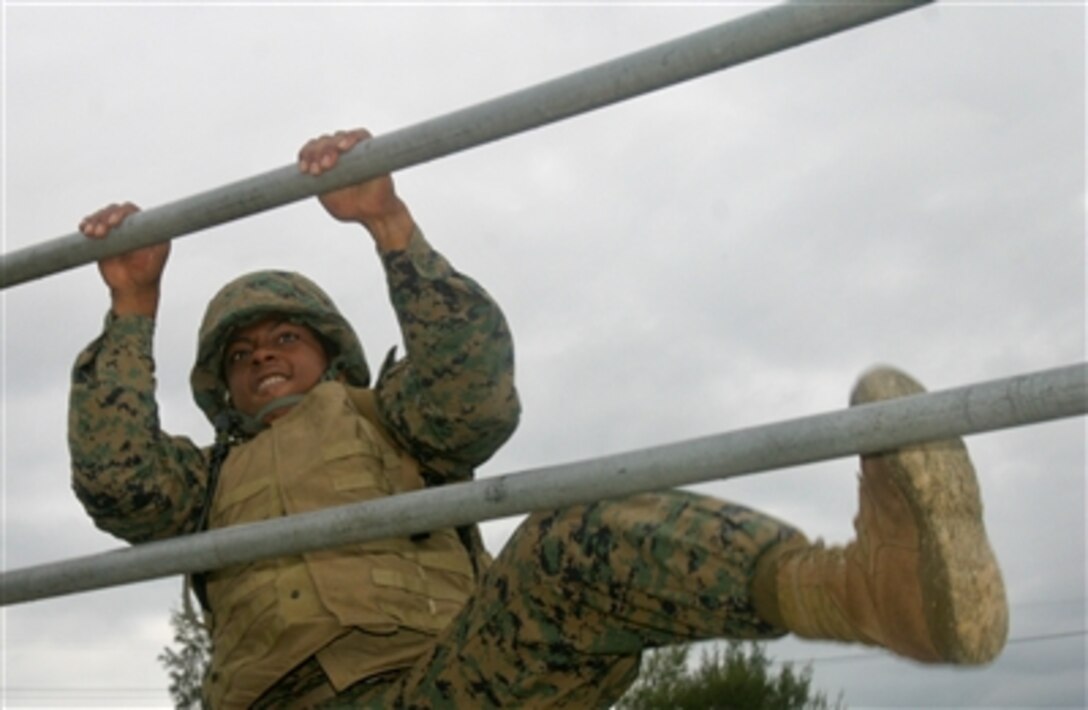 Pfc. David Thomas negotiates the Camp Courtney Obstacle Course in Okinawa, Japan,  Oct. 27, 2006, during a Combat Lifesaver Course designed to teach Marines how to treat wounded servicemembers during combat.




