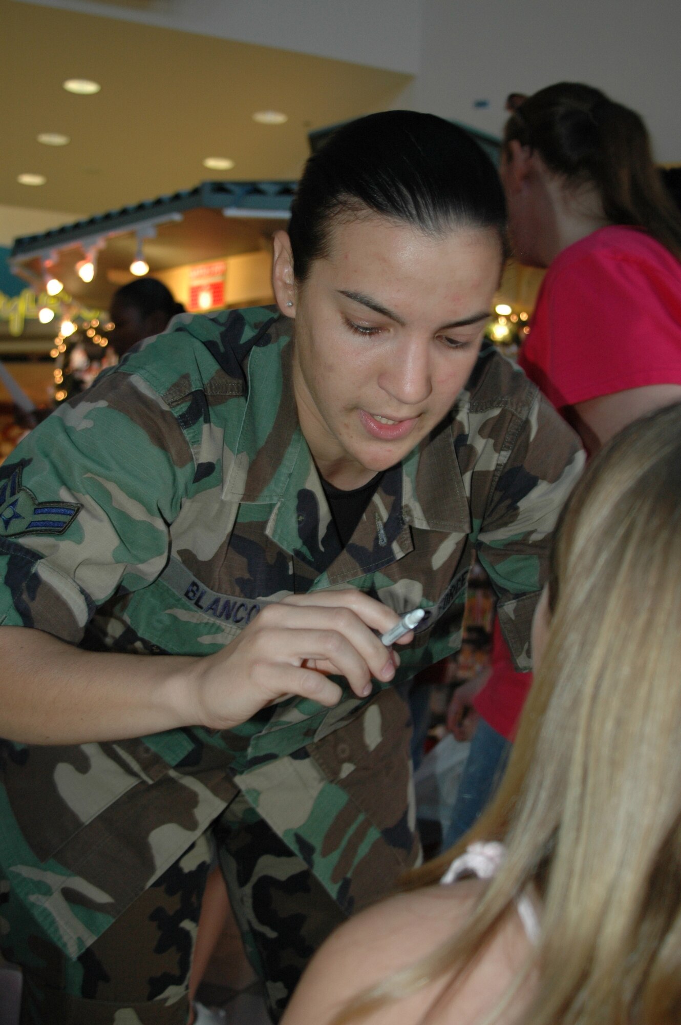 Airman 1st Class Mirtha Blanco, 15th Medical Group Public Health, administers the flu mist to a patient Saturday at the Navy Exchange. Air Force, Navy and Army medical members were on hand Friday and Saturday and administered more than 1,200 vaccinations. Also available was information on this year's flu season and Pandemic Influenza. 
