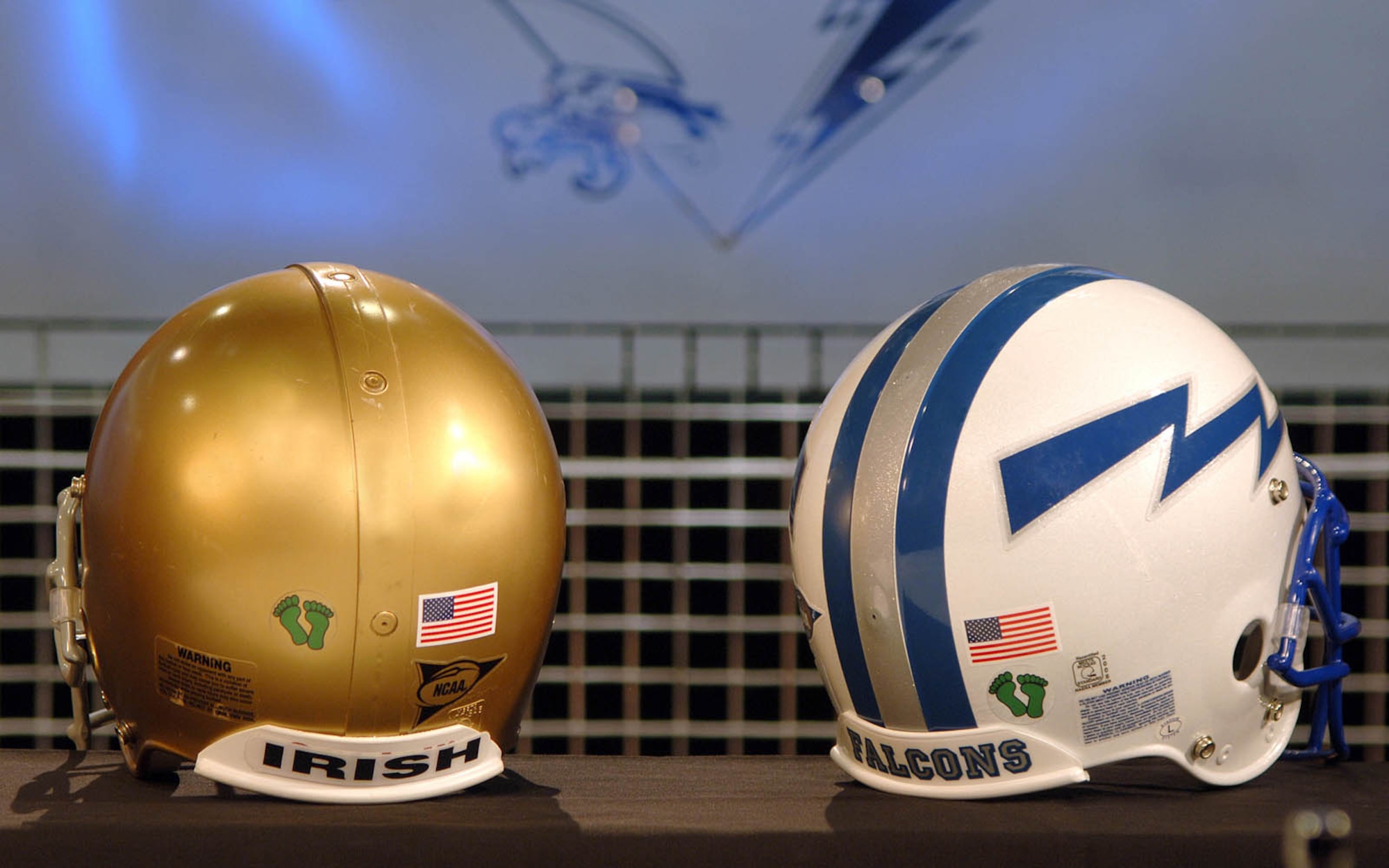 Notre Dame and Air Force football helmets are shown sporting the six-toe, Jolly Green feet logo representing the Air Force rescue community. The teams will wear the added decal for their Veterans Day game to honor those who serve so other may live. (U.S. Air Force photo/Danny Meyer)     
