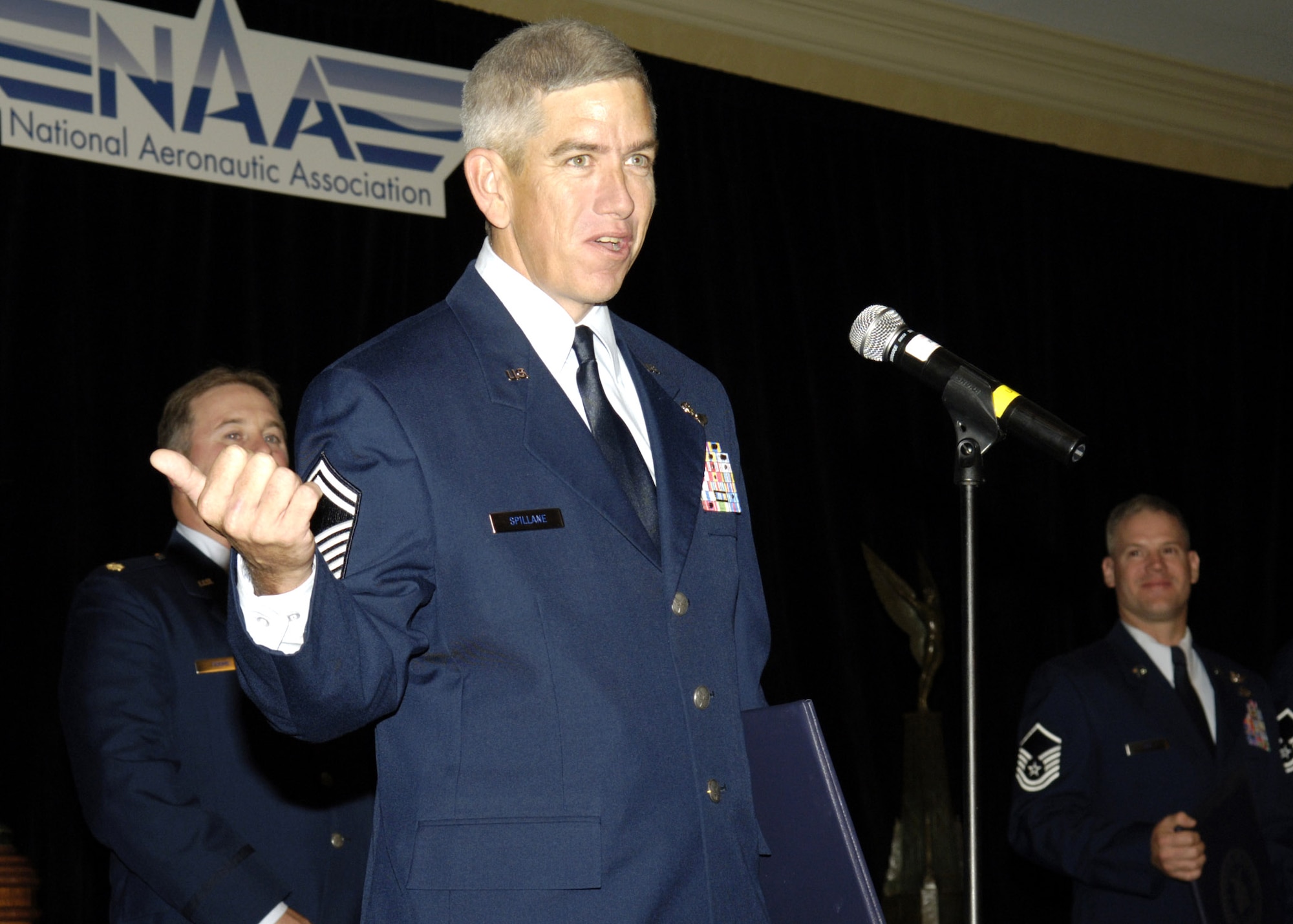 Senior Master Sgt. John Spillane recounts the mission that earned his C-130 Hercules crew the 2005 Clarence Mackay Trophy during a presentation ceremony in Arlington, Va., on Nov. 6.  Vice Chief of Staff of the Air Force Gen. John D. W. Corley presented the trophy to Maj. Michael Frame, pilot; Maj. Brian Lewis, instructor pilot; Sergeant Spillane, instructor loadmaster; Master Sgt. Thomas Lee, instructor flight engineer; and Master Sgt. Corey Turner, instructor loadmaster. The crew was assigned to the 777th Expeditionary Airlift Squadron in Iraq.  (U.S. Air Force photo/Donna Parry)