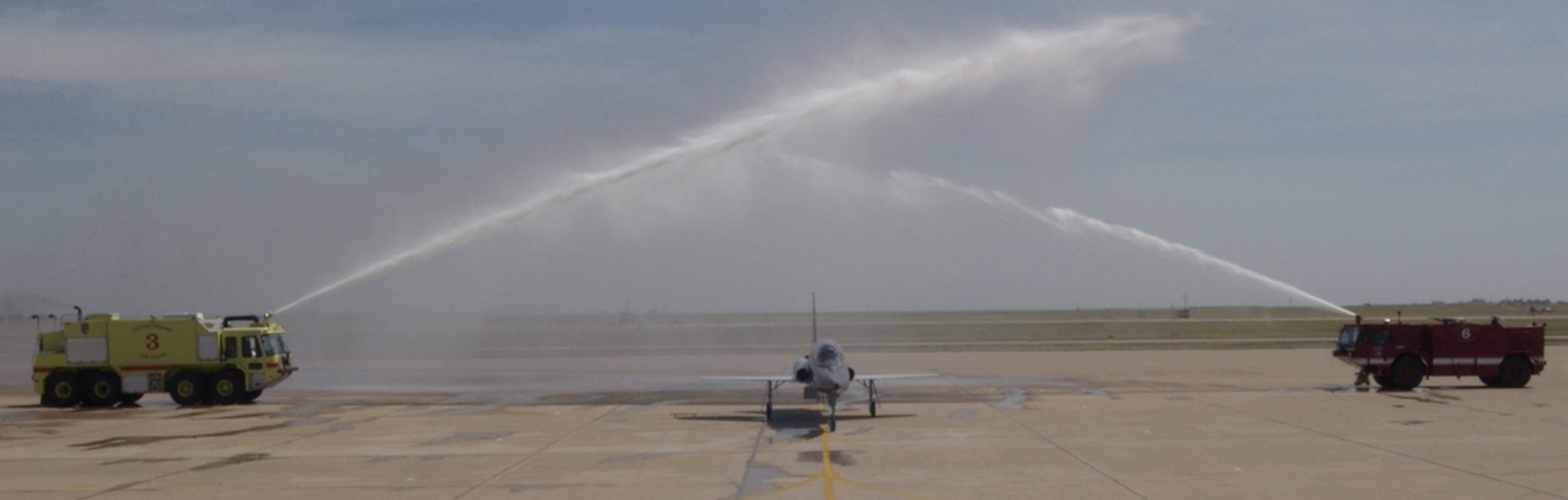 The last AT-38 Talon to fly a mission in the Air Force is given a salutory bath after its final flight April 14 here. Col. Jeffrey Kendall, 80th Flying Training Wing commander, and Lt. Col. Richard McCool, commander of the 88th Flying Training Squadron, were the two pilots to make the historic flight. The T-38C is replacing the aircraft used for introduction to fighter fundamentals.  (U.S. Air Force photo/Sandy Wassenmiller).