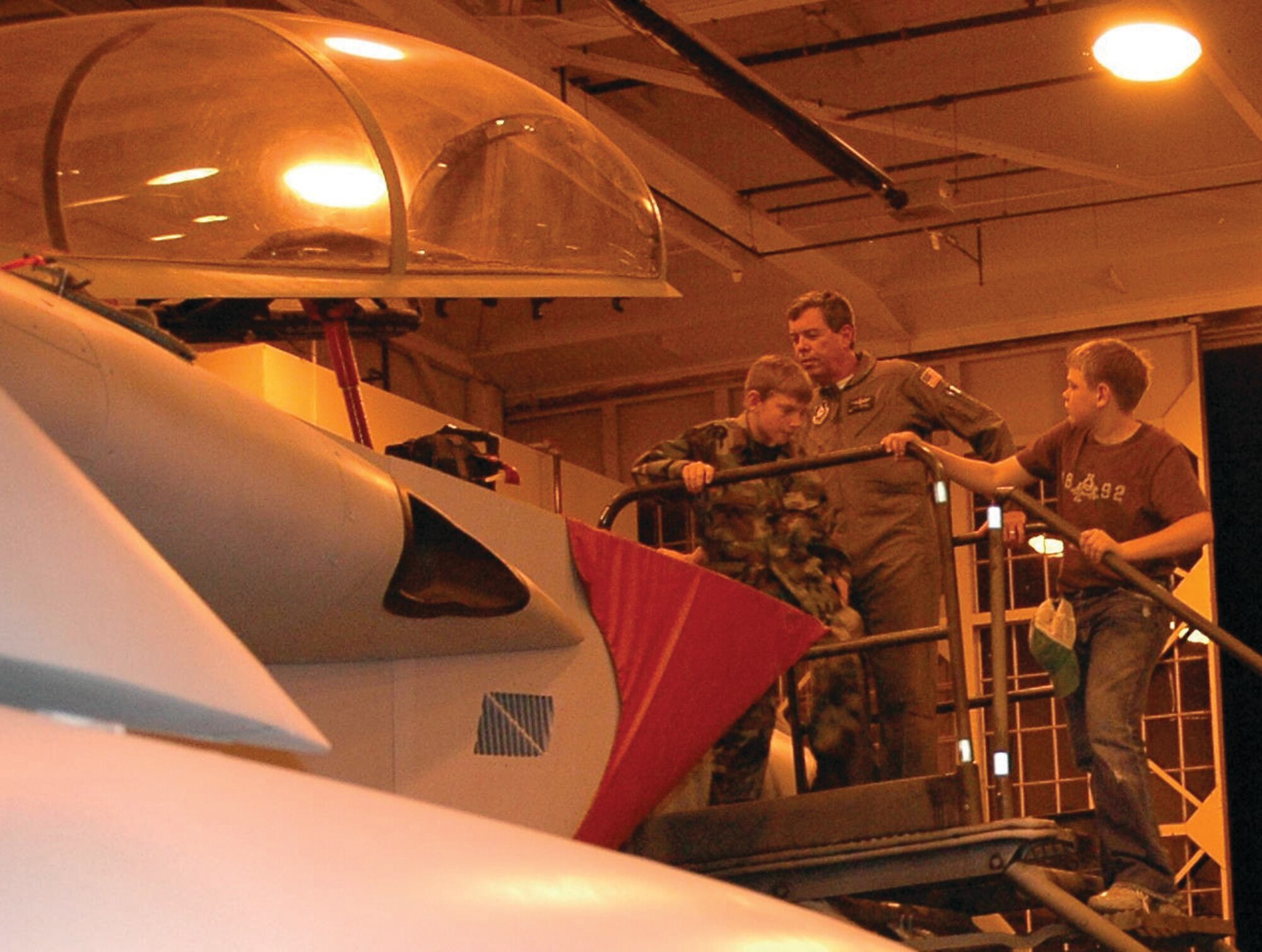 Cadet Aaron Stafford from the Civil Air Patrol Rio del Fierro Composite Squadron Tx-430 exits the cockpit of an F-15 Eagle March 30 as CAP Maj. Russ Melvin waits for the next guest to look at the aircraft. (U.S. Air Force Photo).