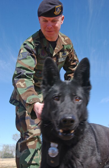 Staff Sgt. Andrew Odell, a 71st Security Forces Squadron K-9 handler, and his military-working dog, Cini, helped the Enid Police Department locate a potential bomb March 9 during a bomb-threat investigation at a local school.(Photo by Frank McIntyre)