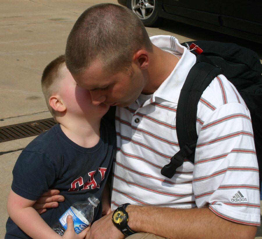 Braxton Brittian places a kiss on his father’s cheek Saturday afternoon before the final group of 82nd Civil Engineer Squadron personnel head to Colorado for training with the Army at Fort Carson. Senior Airman Brett Brittian works in the structural shop at the CES. (U.S. Air Force photo/Mike McKito).