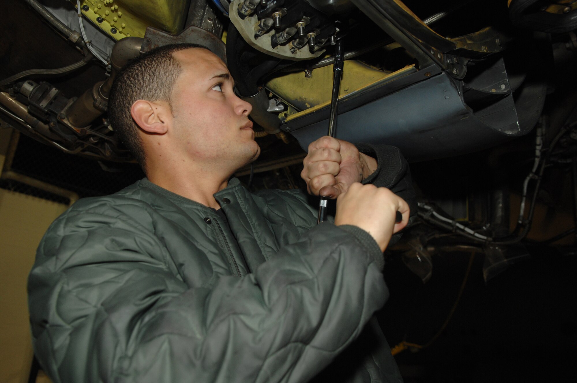 MINOT AIR FORCE BASE, N.D. -- Airman 1st Class Ismael Rodriguez, 5th Maintenance Squadron jet engine mechanic, unfastens bolts to a generator connected to the engine of a B-52H Stratofortress here Tuesday during a phase inspection. The B-52 usually goes through twelve days of repairs during the inspection before its ready to fly again.(U.S. Air Force photo by A1C Christopher Boitz)