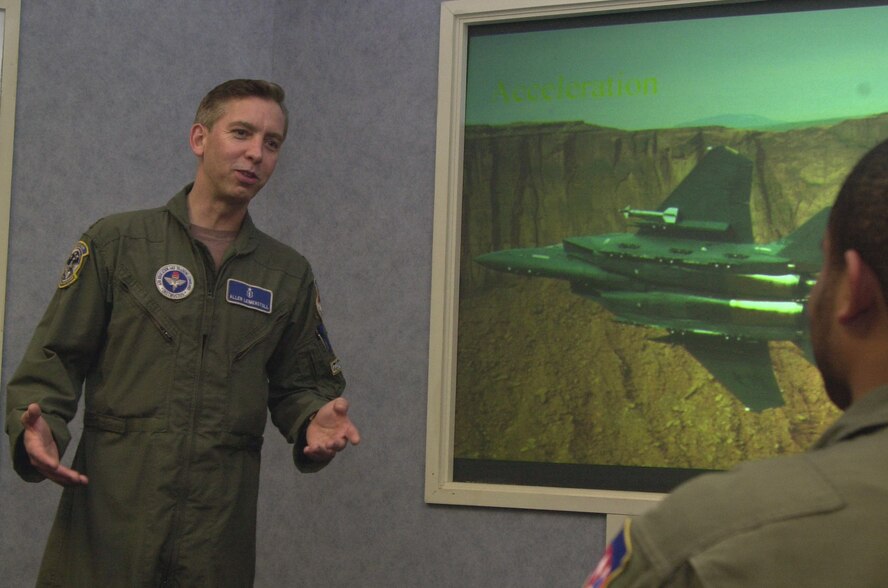 Maj. Allen Leimenstoll, 71st Medical Operations Squadron, tells a class about the effects aircraft acceleration have on a pilot. Major Leimenstoll was named the Air Force’s Aerospace Physiology Field Grade Officer of the Year for 2005. He is the aerospace physiology flight commander at Vance Air Force Base.(Photo by Frank McIntyre)