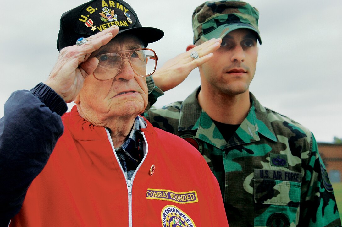 WESTOVER AIR RESERVE BASE, Mass. -- World War II veteran Armond J. Baron and Tech. Sgt. Christopher Harry salute the flag at the Base Ellipse. (US Air Force photo/Senior Master Sgt. Sandi Michon)