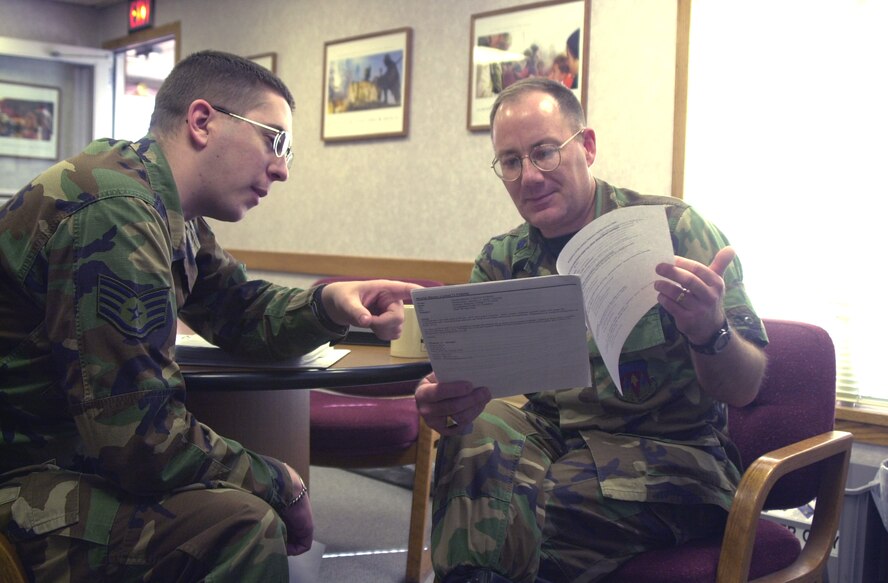 Staff Sgt. Stephen Huffman, 71st Flying Training Wing chapel NCO in charge, reviews chapel information with Chaplain (Lt. Col.) Steven Nicolai, 71st FTW chaplain.(Photo by Frank McIntyre)
