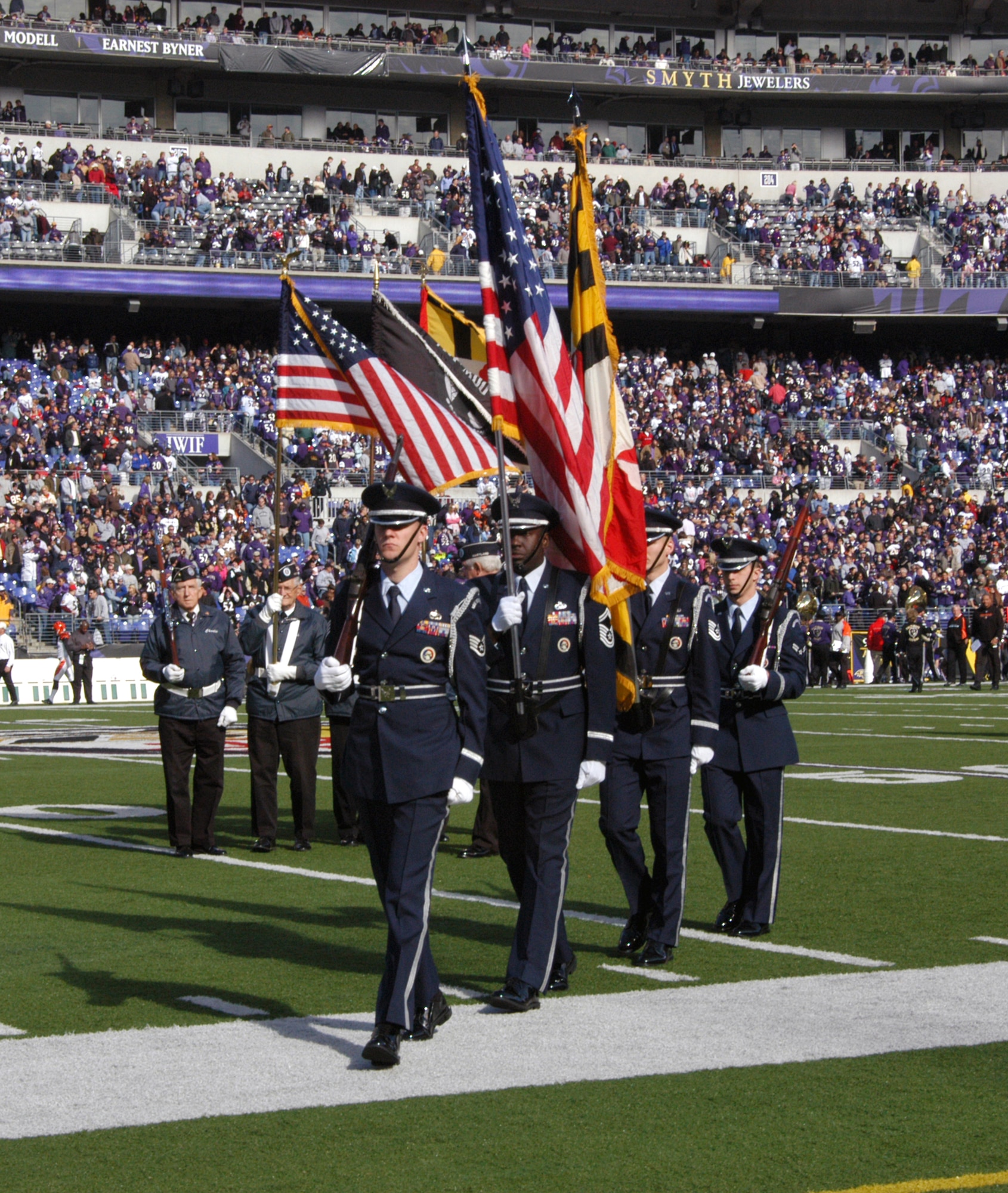 Senior Master Sgt. Mitchell Ross, Tech. Sgt. Aaron Arneson, Staff Sgt. Justin Mealy and Airman First Class Ian Kilbourn depart the Baltimore Ravens field Nov. 5 after presenting the colors as part of the pre-game show in front of a crowd of nearly 71,000 fans. The four Airmen are assigned to the 70th Intelligence Wing at Fort Meade, Md. (U.S. Air Force photo/Tech. Sgt. Martin Jackson) 

