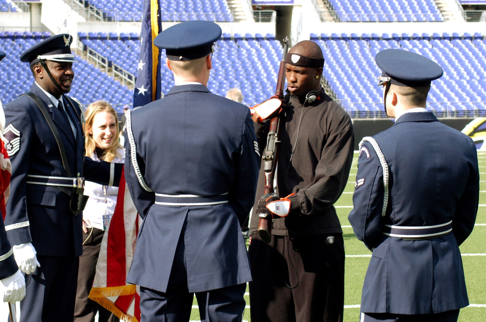 Chad Johnson, Cincinnati Bengals wide receiver, gets in a pre-game workout with the 70th Intelligence Wing Honor Guard before playing in the NFL football game against the Baltimore Ravens Nov. 5. Four Airmen from 70th Intelligence Wing at Fort Meade, Md., presented the colors as part of the pre-game show in front of a crowd of nearly 71,000 fans. The honor guard memvers were Senior Master Sgt. Mitchell Ross, Tech. Sgt. Aaron Arneson, Staff Sgt. Justin Mealy and Airman First Class Ian Kilbourn. (U.S. Air Force photo/Tech. Sgt. Martin Jackson) 
