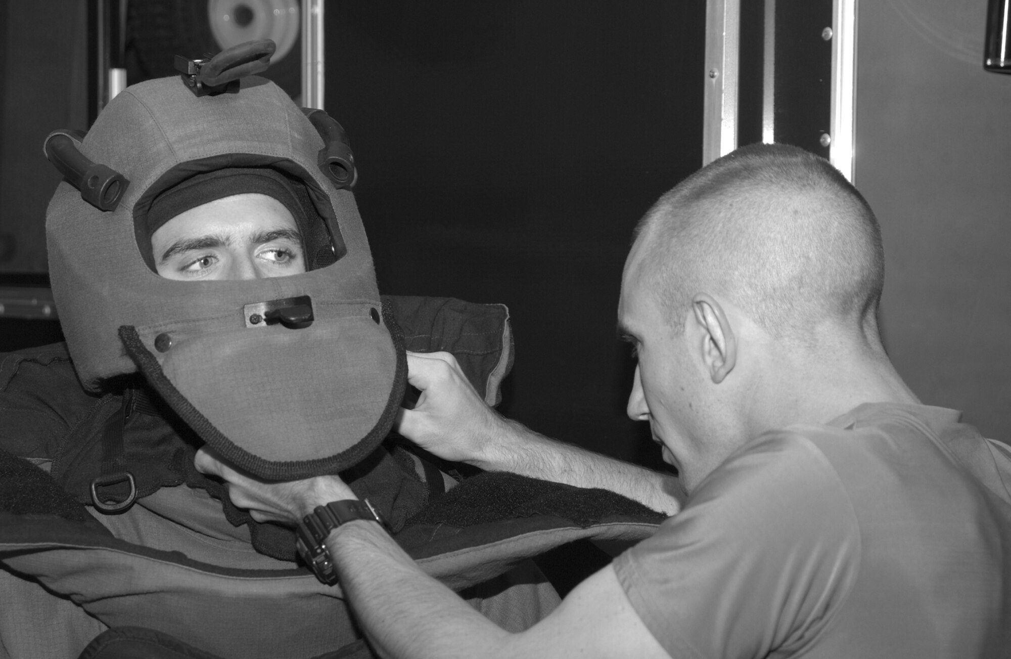 Staff Sgt. Kevin Hammer (right), an explosive ordnance disposal craftsman with the 39th Civil Engineer Squadron, adjusts the straps on Staff Sgt.Ryan Bobzin's, 39th CES explosive ordnance disposal journeyman, bio suit during a bioenvironmental exercise. (U.S. Air Force photo by Airman Nathan Lipscomb)