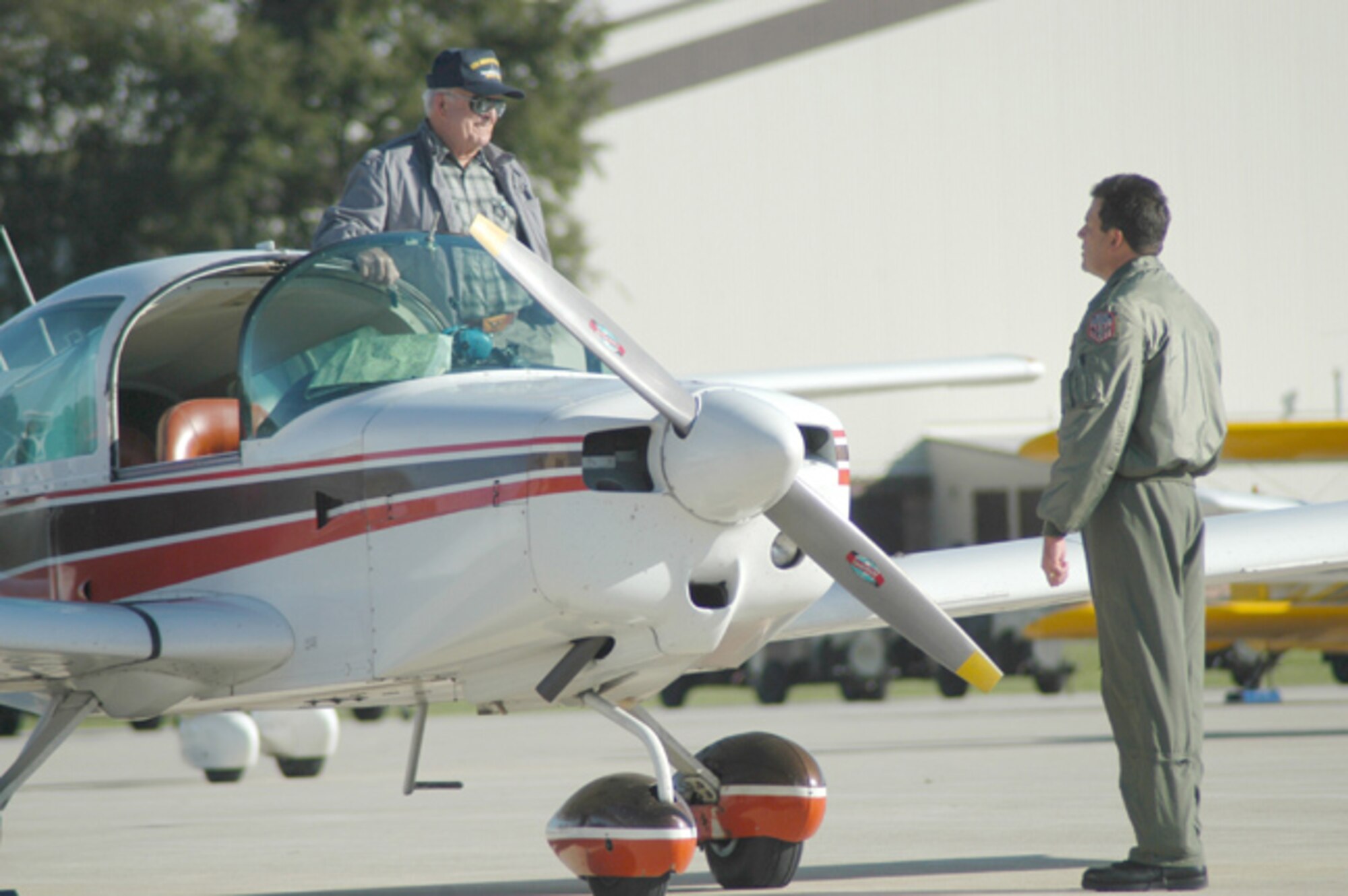 GRISSOM AIR RESERVE BASE, Ind., -- Senior Master Sgt. Jeff Henry, a boom operator  with the 74th Air Refueling Squadron, welcomes Truman Millerto the civilian fly-in. Mr. Miller and his wife Joyce flew from Sturgis, Mich., to participate in a special fly-in at Grissom on Oct. 14. The event was designed to promote flying safety between civilian pilots and the flying units at Grissom.  (U.S. Air Force photo/Tech. Sgt. Doug Hays)