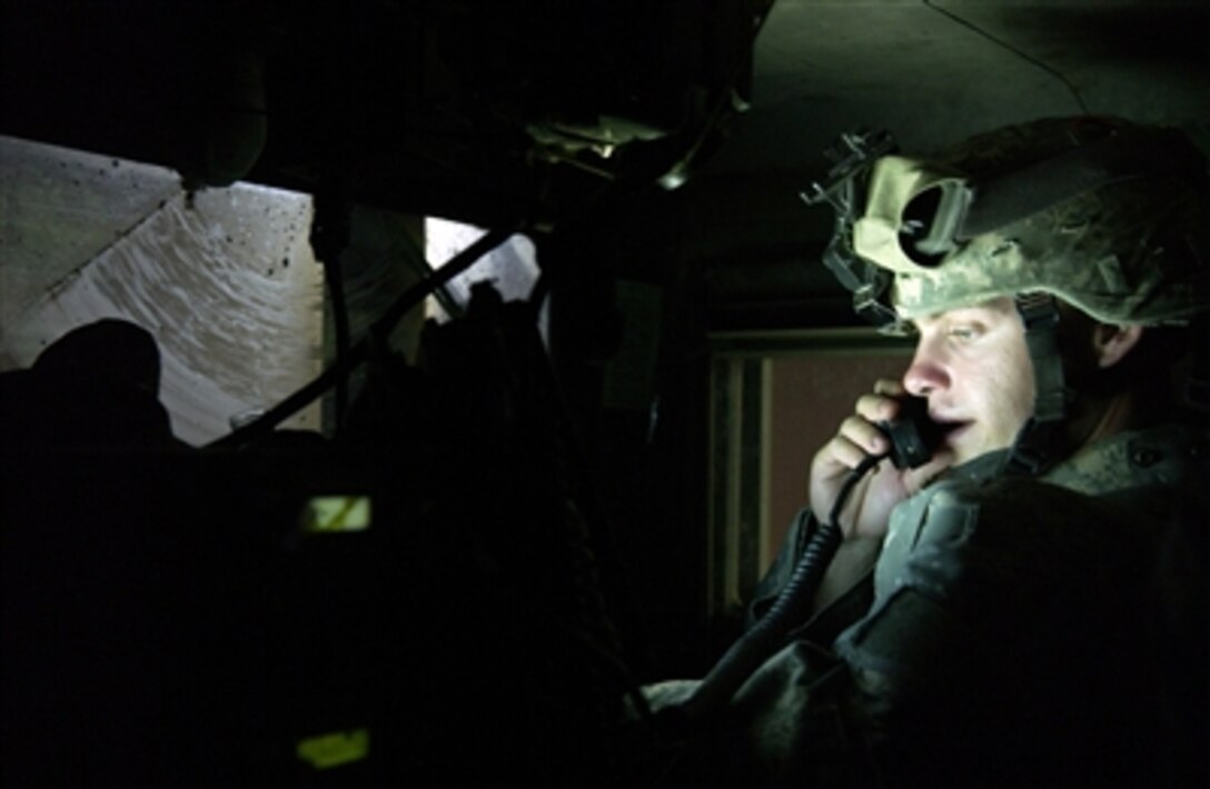 U.S. Army Staff Sgt. Shawn Smith watches his Blue Force Tracker while communicating with others within his convoy during a patrol in Kirkuk, Iraq, on Nov. 4, 2006.  The Blue Force Tracker gives real-time location of friendly forces on the battlefield.  Smith is a patrol leader from Bravo Company, 2nd Battalion, 35th Infantry Regiment, 25th Infantry Division.  