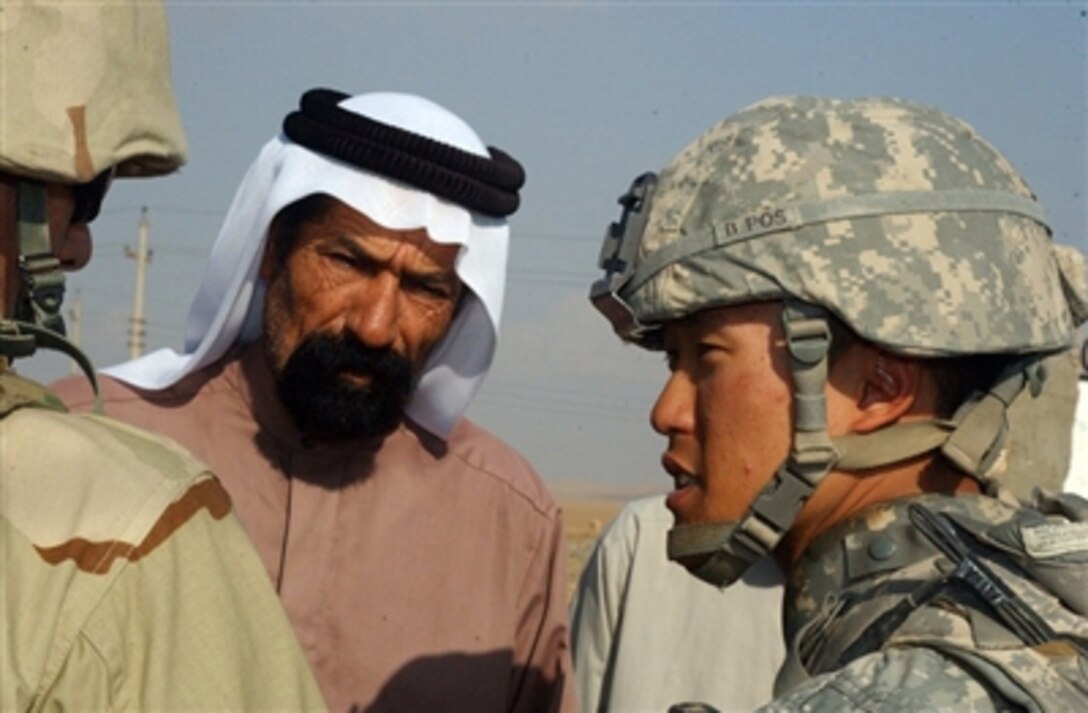 U.S. Army 1st Lt. Thomas Cho talks with the aid of a translator to a village official in Khueayrat, Iraq, on Oct. 30, 2006.  Cho and other members of the 5th Battalion, 20th Infantry Regiment, 3rd Stryker Brigade Combat Team, 2nd Infantry Division are patrolling in the area.  