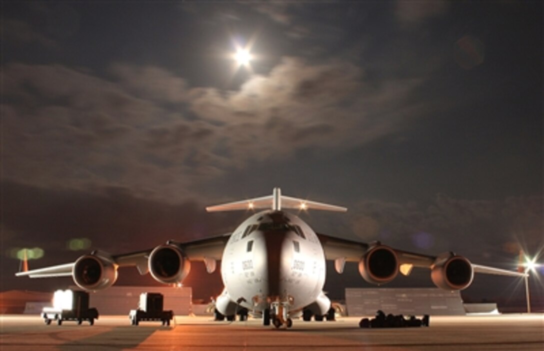 A C-17 Globemaster III, belonging to 62nd Airlift Wing, McChord Air Force Base, Wash., rests on the tarmac at McConnell Air Force Base, Kan., Nov. 4, as the crew and members of the 22nd Logistics Readiness Squadron load the aircraft before a mission to Southwest Asia. 