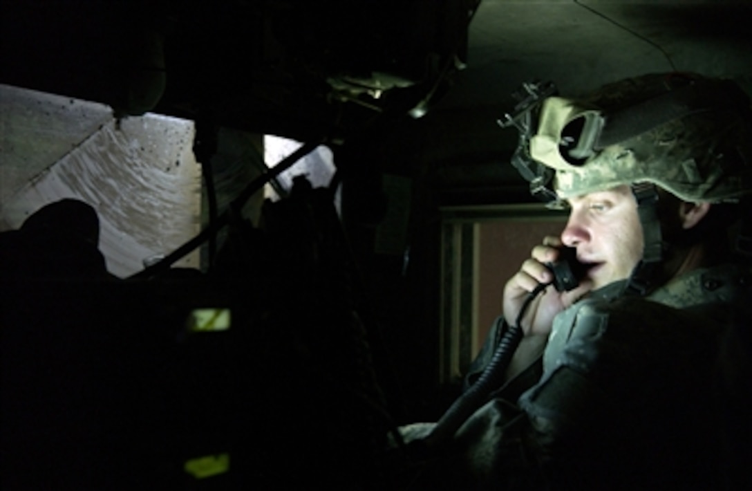 U.S. Army Staff Sgt. Shawn Smith watches his Blue Force Tracker while communicating with others within his convoy during a patrol in Kirkuk, Iraq, on Nov. 4, 2006.  The Blue Force Tracker gives real-time location of friendly forces on the battlefield.  Smith is a patrol leader from Bravo Company, 2nd Battalion, 35th Infantry Regiment, 25th Infantry Division.  