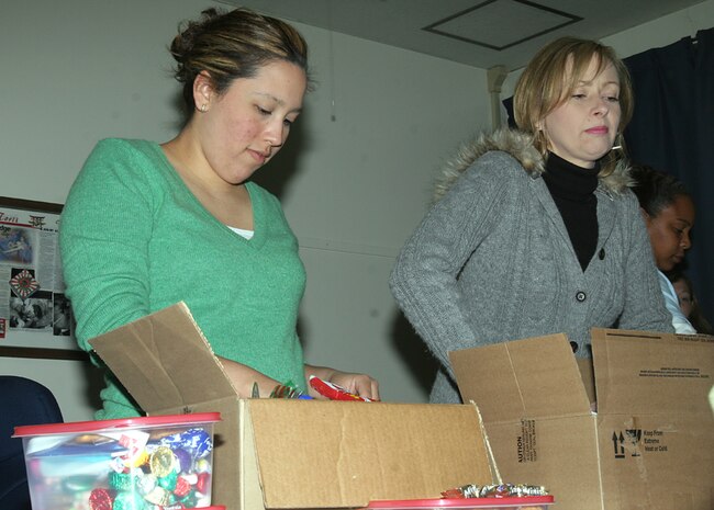 Darlene M. Tuttle, CLC-36 spouse and Corpus Christi, Texas native, and Beth A. Kohutek, CLC-36 spouse and Bohemia, N.Y. native, pack items for care packages to be sent to CLC-36 Marines in Iraq. ?We are a small unit, and it?s important to let our Marines know they?re important to us,? Kohutek said.