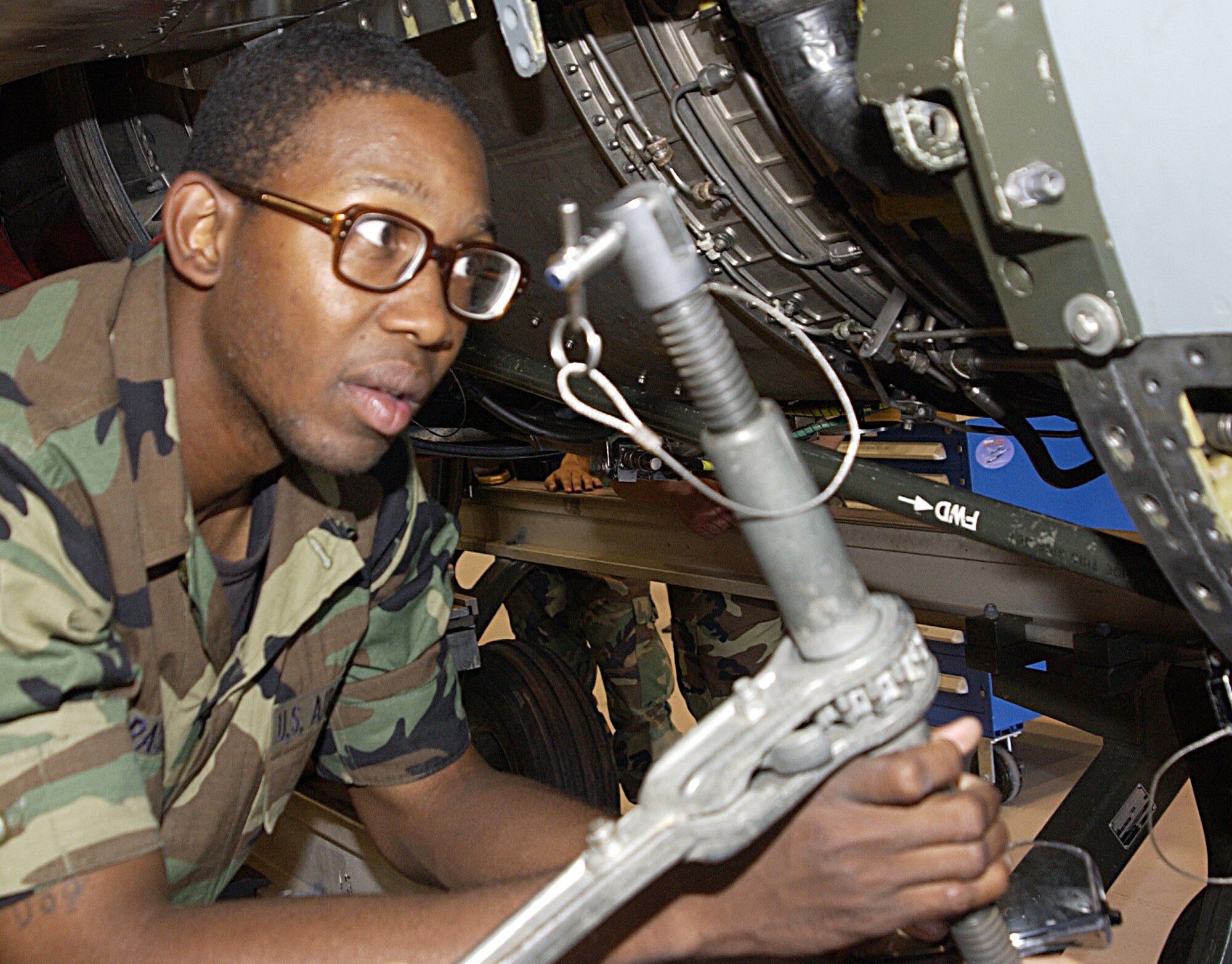 Airman Naim Rasheeb hooks up support brace in preparation to remove an engine from an F-16 at the 361st Training Squadron. (U.S. Air Force photo/Harry Tonemah).
