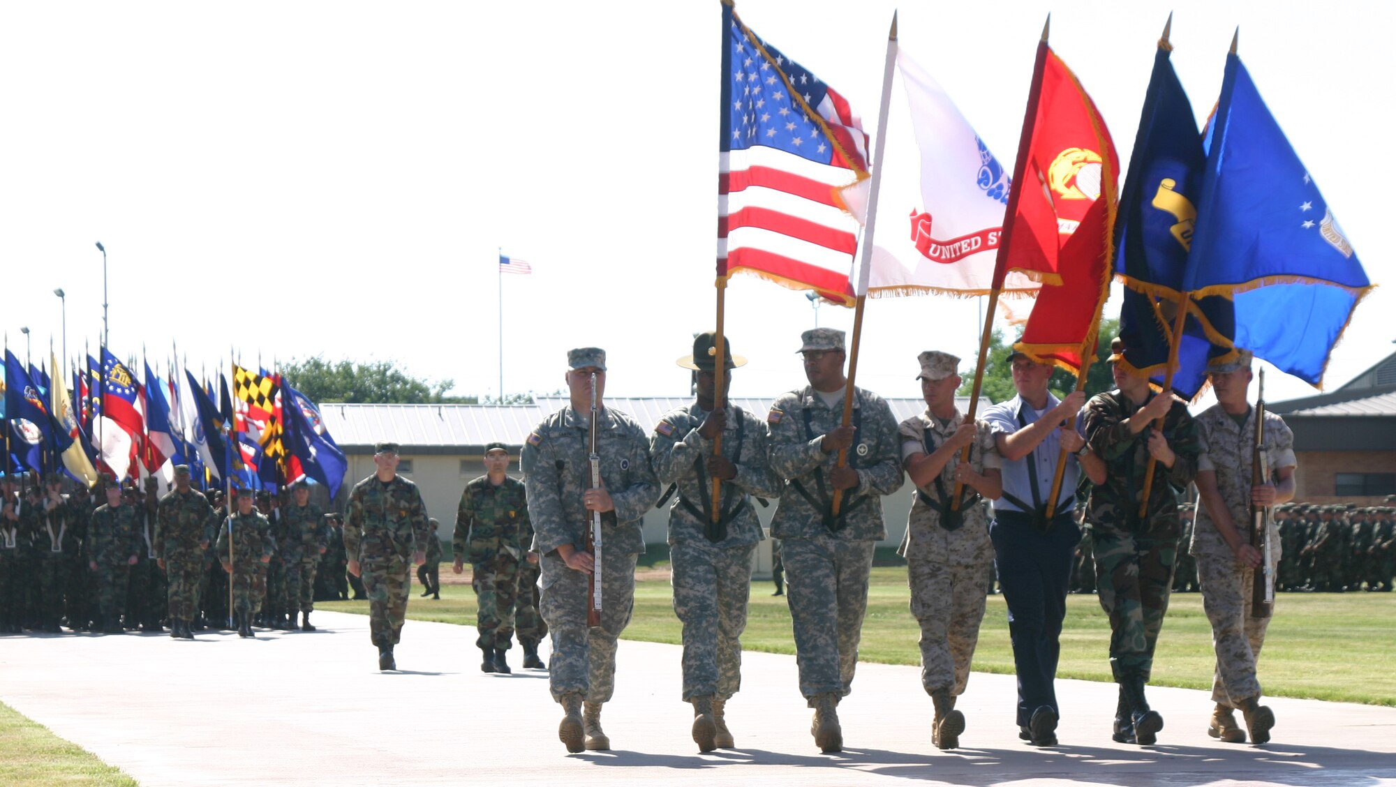 Airmen, Sailors, Soldiers and Marines carry the colors May 20 during the Armed Forces Day parade at the new parade ground. (U.S. Air Force photo/John Ingle).