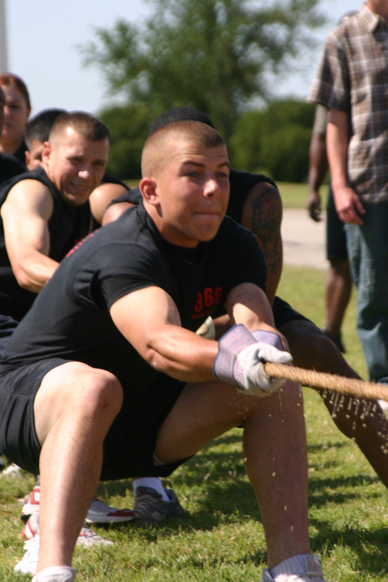 Justin Bourg pulls at the front of the rope with his teammates from the 366th Training Squadron during the tug-of-war event, Saturday at the Joint Warrior Competition. The competition was held as part of Armed Forces Week celebrations here at Sheppard.  (U.S. Air Force photo/Airman Jacob Corbin).