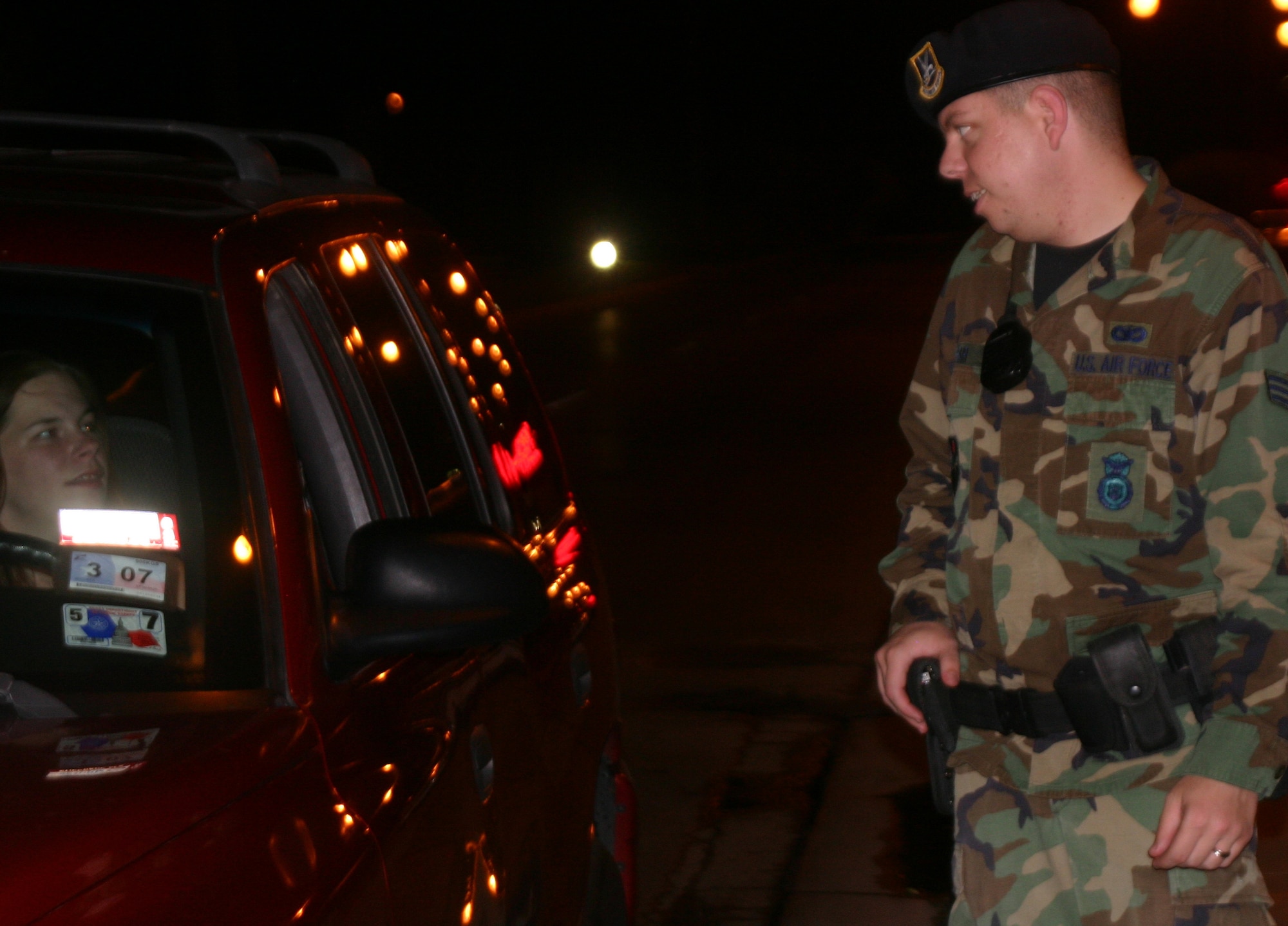 Senior Airman Brian Fair, a member of the 82nd Security Forces Squadron, talks to a driver at the main gate recently. Protecting the gates is the front line of defense for the 82nd SFS.  (U.S. Air Force photo/Robert Fox)