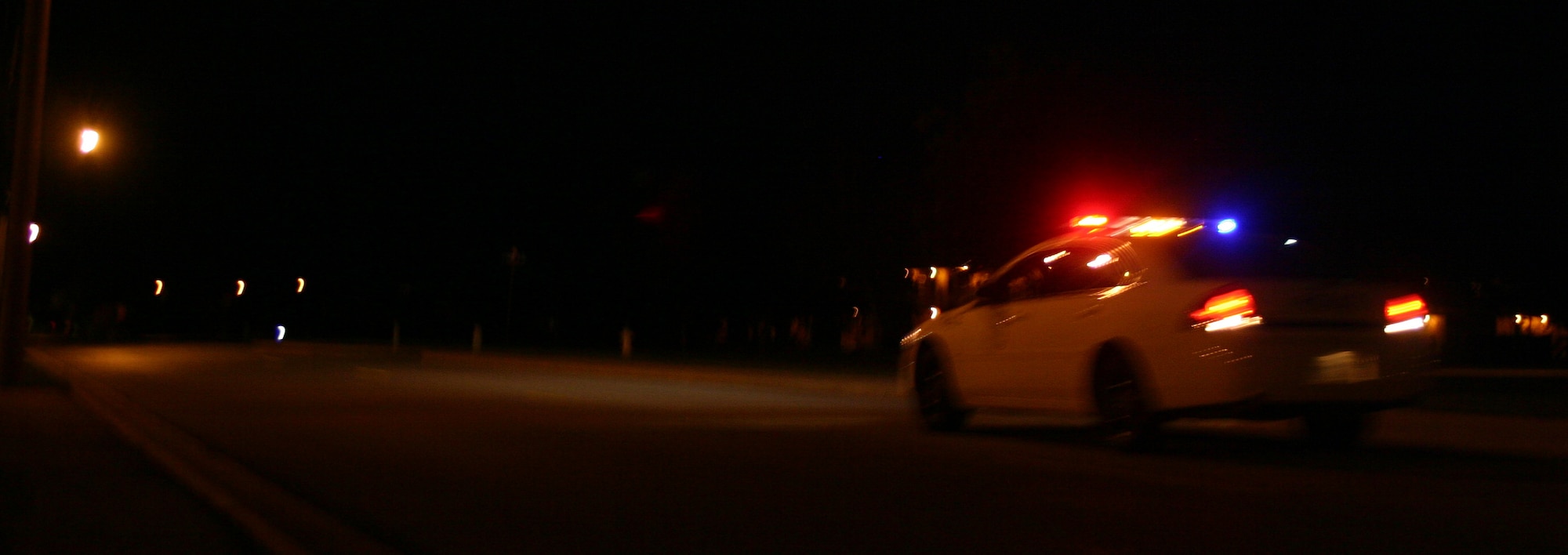 While base residents are asleep in their beds, the 82nd Security Forces Squadron is out ensuring their safety. Here, an 82nd SFS patrol car races to an emergency on base. (U.S. Air Force photo/Robert Fox)