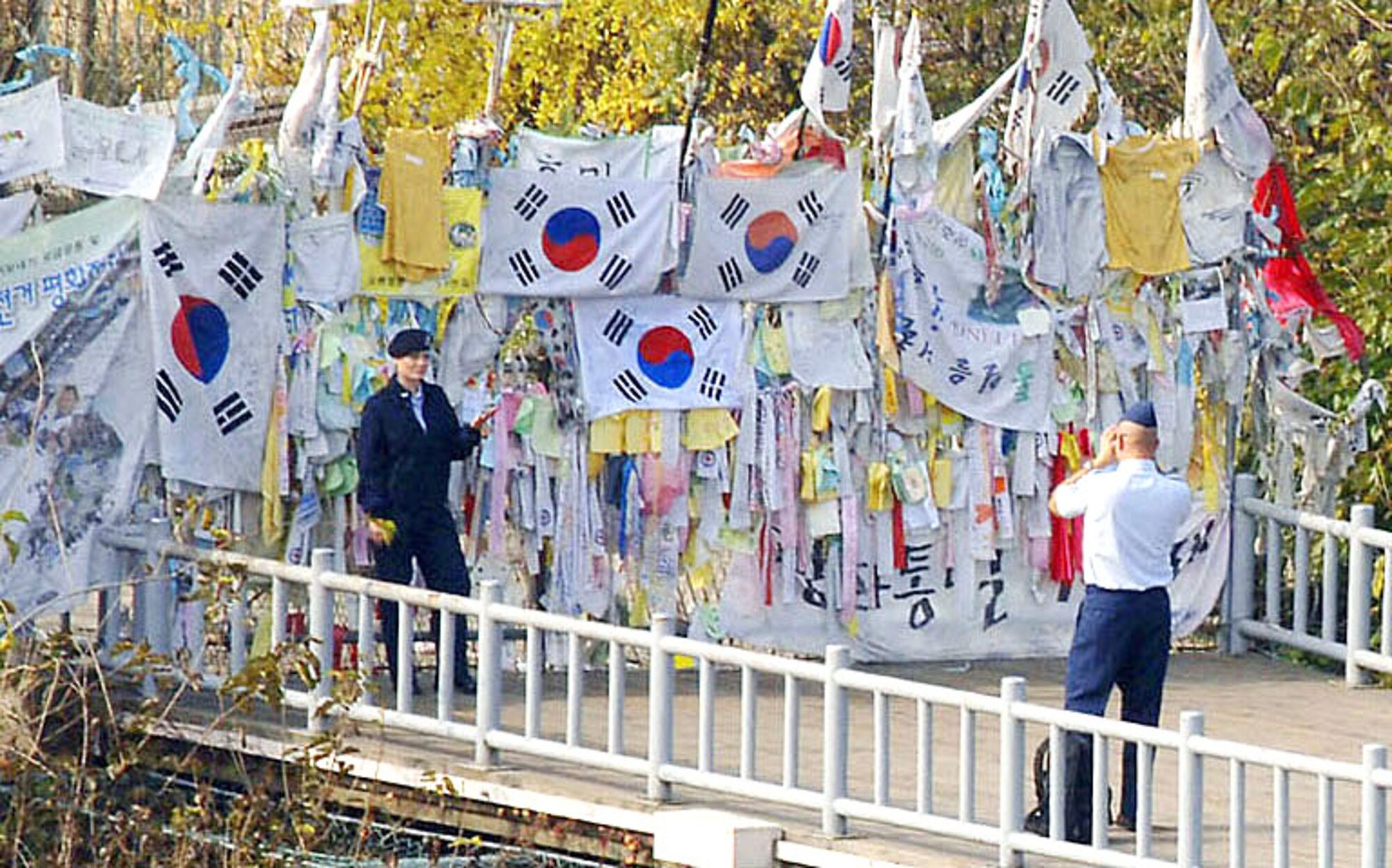 An Airman poses in front of the "Freedom Wall" where South Koreans post messages for their kin to the North. Airmen from the 8th Fighter Wing at Kunsan Air Base spent the day at the demilitarized zone, or DMZ, an area that separates the democratic 