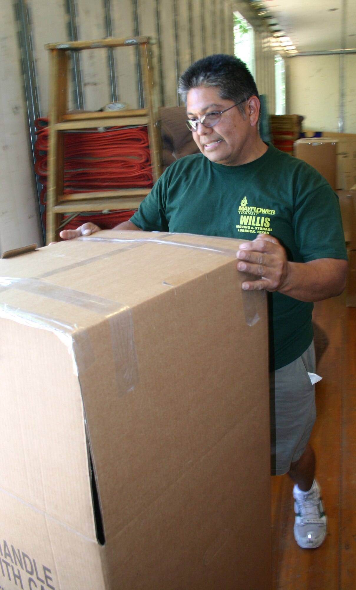 Philip Pouda, a mover with Mayflower Transit, situates a box inside a moving truck Tuesday afternoon. The summer months are the busiest for movers and Sheppard’s traffice management office. (U.S. Air Force photo/Senior Airman Jacque Lickteig).