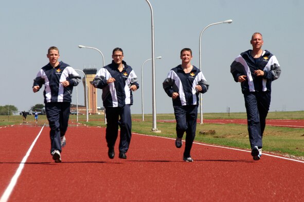 Dave Max, Derek Rowe, Randy Lund and Mark Roberts test out their Air Education and Training Command marathon team uniforms prior to leaving for the 10th annual Air Force marathon Saturday at Wright-Patterson Air Force Base, Ohio. (U.S. Air Force photo/Airman Jacob Corbin)