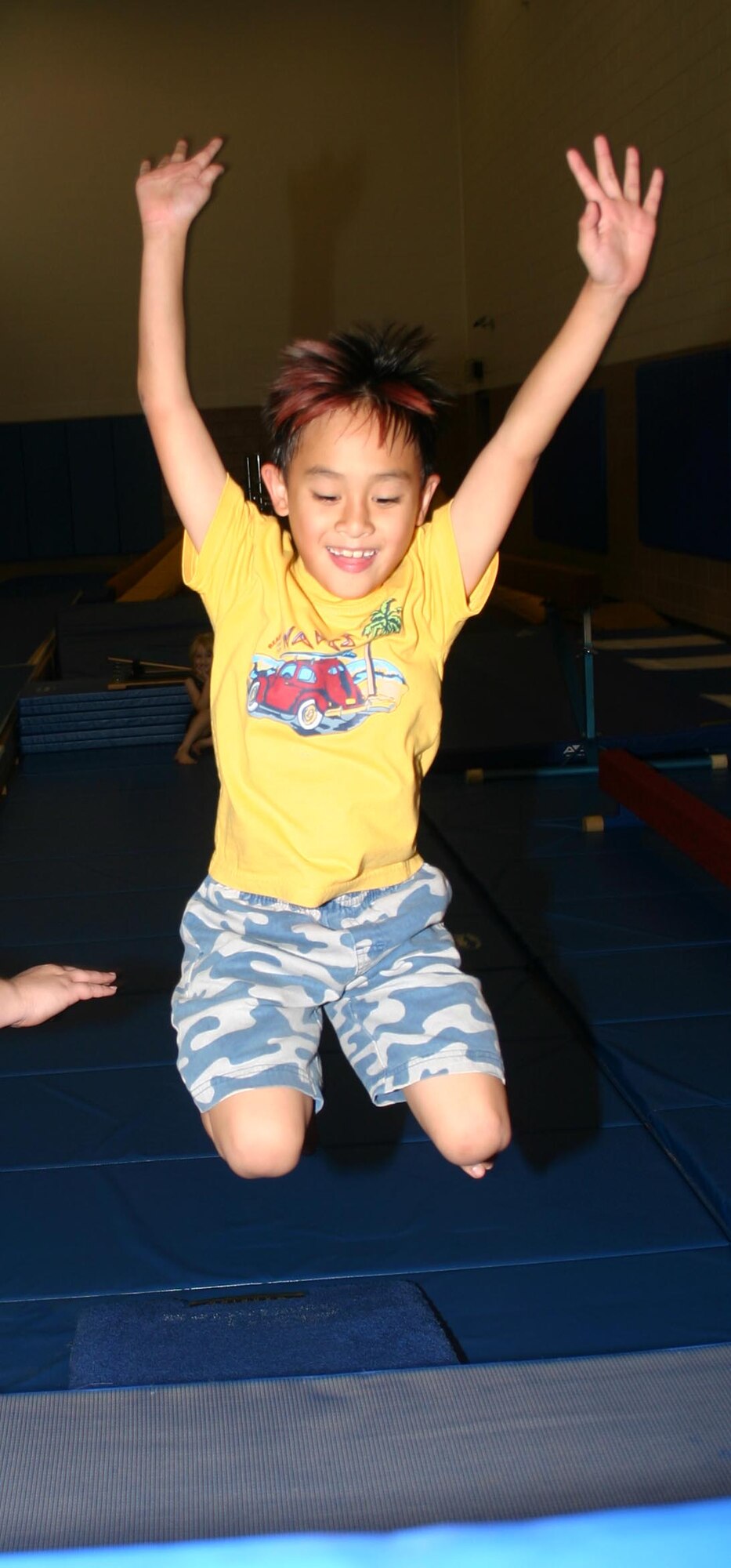 Shane Donovan jumps while participating in the KinderGym class at the Madrigal Youth Center. (U.S. Air Force photo/Senior Airman Jacque Lickteig).
