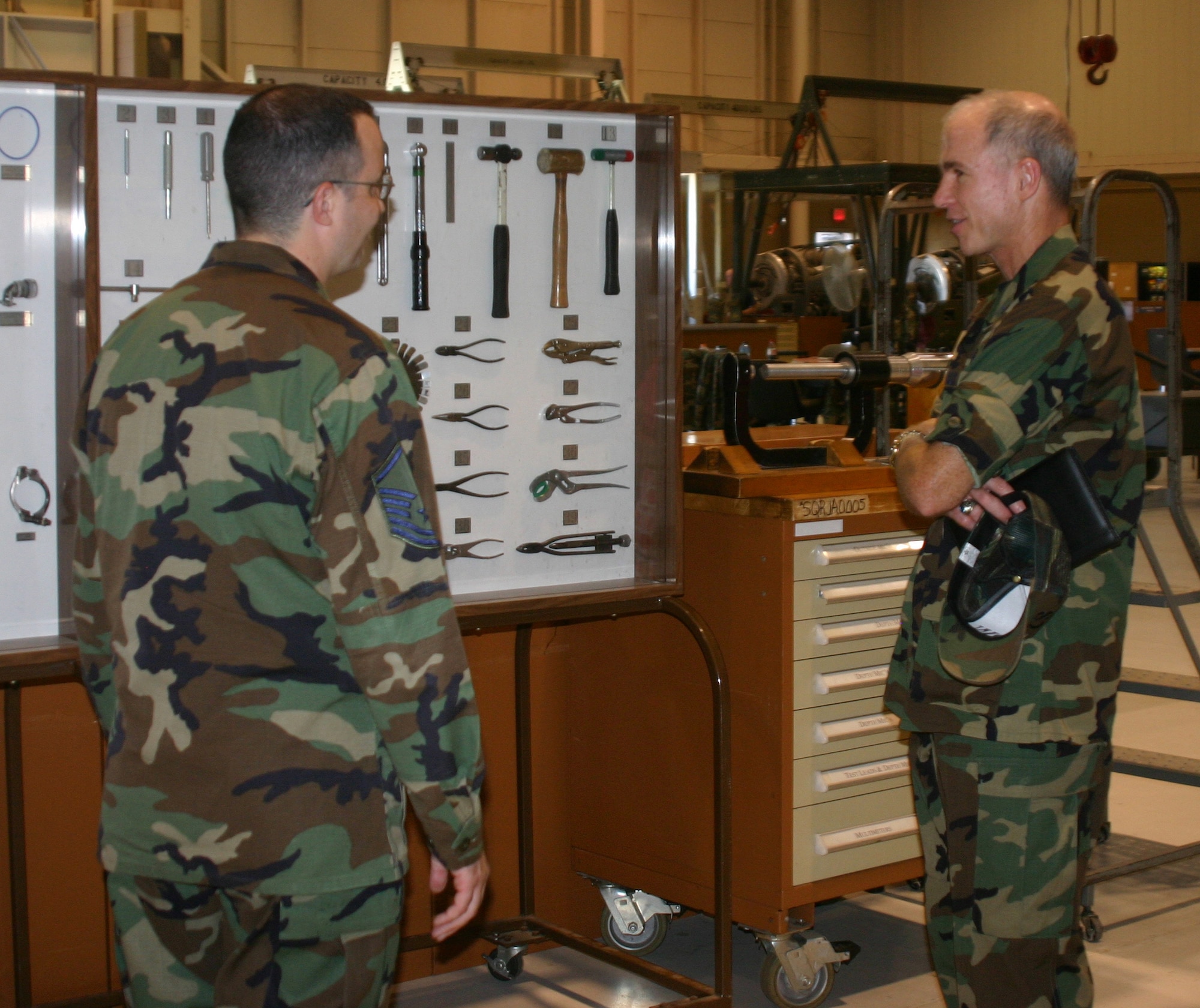 Master Sgt. David Meany tells Brig. Gen. Richard Devereaux, 82nd Training Wing commander, how the 361st Training Squadron displays tools Airmen will use in the field. (U.S. Air Force photo/John Ingle)