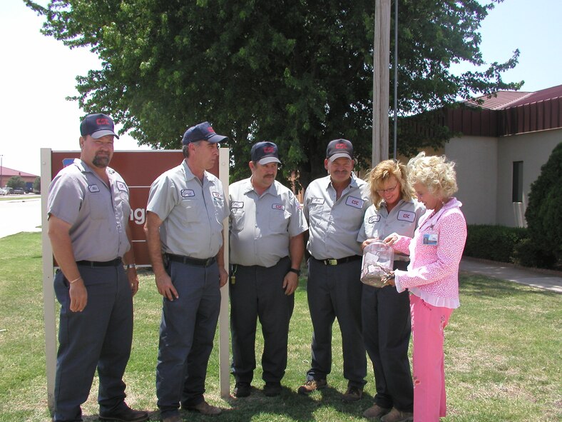 Mike Day, Terrell Cokeley, Jerry Hill, William Fraley and Shiela Humble, resource, recovery and recycling office staff, give cereal-box coupons to Dr. Ruth Erdner from the Enid Public School system Tuesday. The EPS will turn the year and a half’s worth of coupons in for $140. (Photo by Bob Farrell)