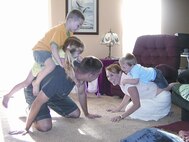 Captain Westby spends quality off-duty time romping with his wife Calley and children Braden, 6, Bryn, 4 and Mason, 2.(Photo by Capt Tony Wickman)