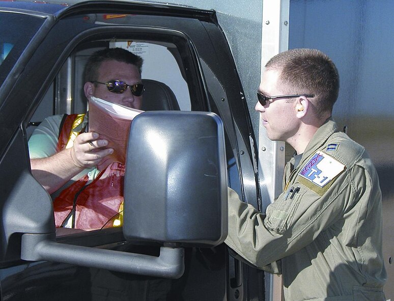 Captain Westby reviews a T-1A maintenance log with aircraft maintenance prior to a student sortie. Before each sortie, the student and instructor pilot prebrief each mission, including weather, maintenance, general knowlege, radio procedures and an aircraft pre-flight inspection. Upon their return, they discuss what happened during the sortie. Captain Westby as flight commander is then responsible for entering and reviewing grade books for his students.(Photo by Capt Tony Wickman)