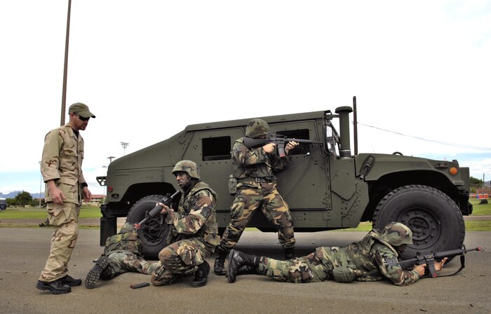 Instructor Jack Anderson watches Airmen from the 15th Airlift Wing return fire during convoy training Nov. 3 at a 3-day Expeditionary Combat Skills training course at Hickam Air Force Base, Hawaii. The Airmen are preparing for the Air Expeditionary Force 5/6 cycle. (U.S. Air Force photo by/Tech. Sgt. Shane A. Cuomo)