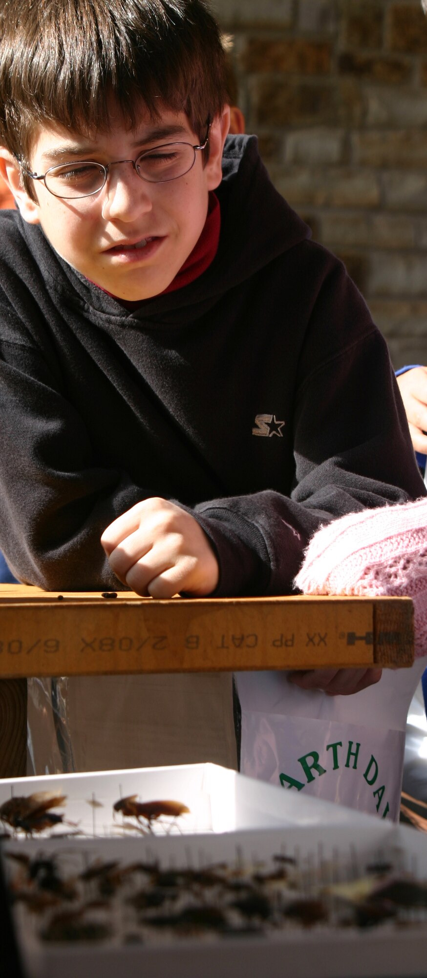 Stefan Lamiroult, a fifth-grade student at City View Elementary, gets an upclose look at Tim Hunters, of the 82nd Civil Engineer Squadron’s Environmental Flight, bug collection on display. (U.S. Air Force photo/John Ingle).