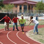 Volunteer Senior Airman Savannah Hawes, 71st Medical Group signals the start of a 100-meter race. More than 300 athletes competed during the Area 6 Special Olympics April 21 at the base fitness center track. More than 100 Team Vance volunteers assisted and cheered athletes on during the day-long competition. (Photo by Terry Wasson) 