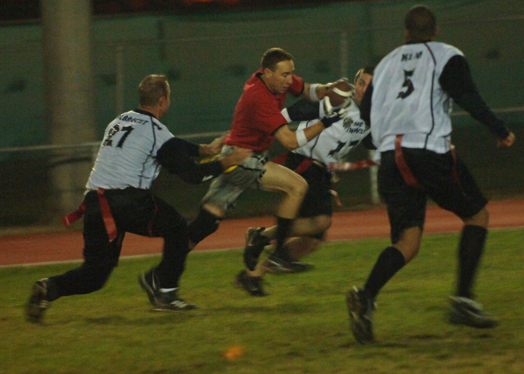 INCIRLIK AIR BASE, Turkey -- Staff Sgt. Daniel Belk,728th Air Mobility Squadron wide reciever,  runs to avoid defenders after making catch during Inramural flag footbal action against the 39th Contracting Squadron/39th Civil Engineer Squadron team Nov. 7.  39th CONS/CES came out on top 19-13, despite being behind early in the first half.  (U.S. Air Force photo by Airman First Class Nathan W. Lipscomb)