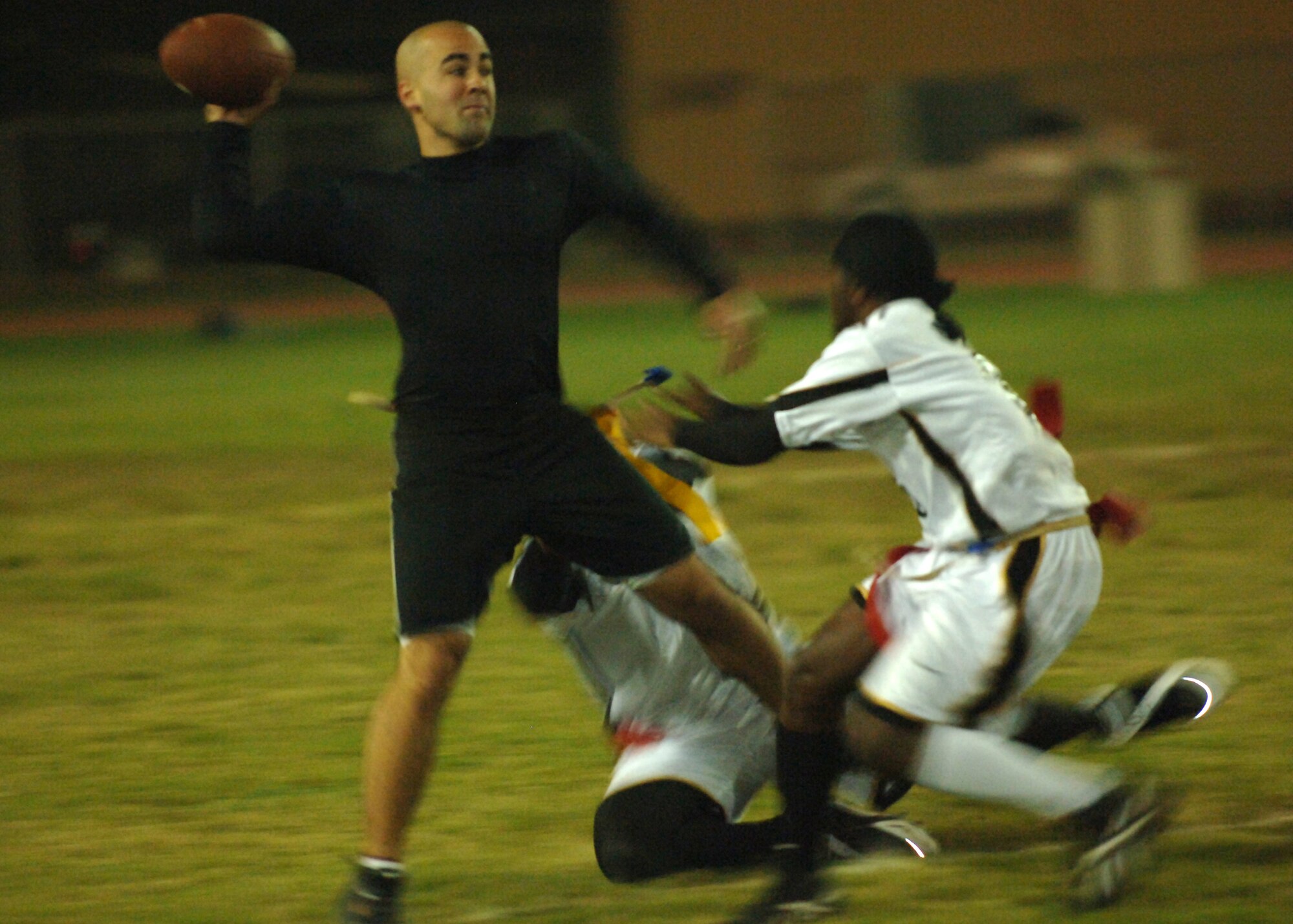 INCIRLIK AIR BASE, Turkey-- Airman First Class Nolan Palazolla,  39th Security Forces Squadron quarterback, keeps his cool in the pocket as the 39th Logistical Readiness Squadron's defense brings pressure during Inramural flag football playoff action Nov. 7.  SFS came out on top 20-19.  (U. S. Air Force photo by Airman First Class Nathan W. Lipscomb)