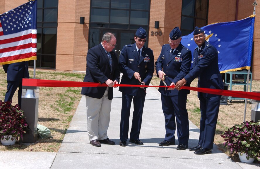 Danny Ohnesorge, Computer Sciences Corporation deputy program manager; Col. Jerry Siegel, 71st Flying Training Wing vice commander; 
Col. Christopher Thelen, 71st Mission Support Group commander; and Maj. Daryl Cunningham, 71st Logistics Readiness Squadron; officially open the Consolidated Logistics Complex Wednesday. Construction on the complex began in February 2005. It is now home to more than 100 employees who work in the 71st LRS squadron offices; base audio-visual support; local purchase offices; quality assurance; Travel Management Office; Services and Information, Ticket and Tours offices; CSC management and human resources offices; and Trend Western offices.(Photo by Frank McIntyre)