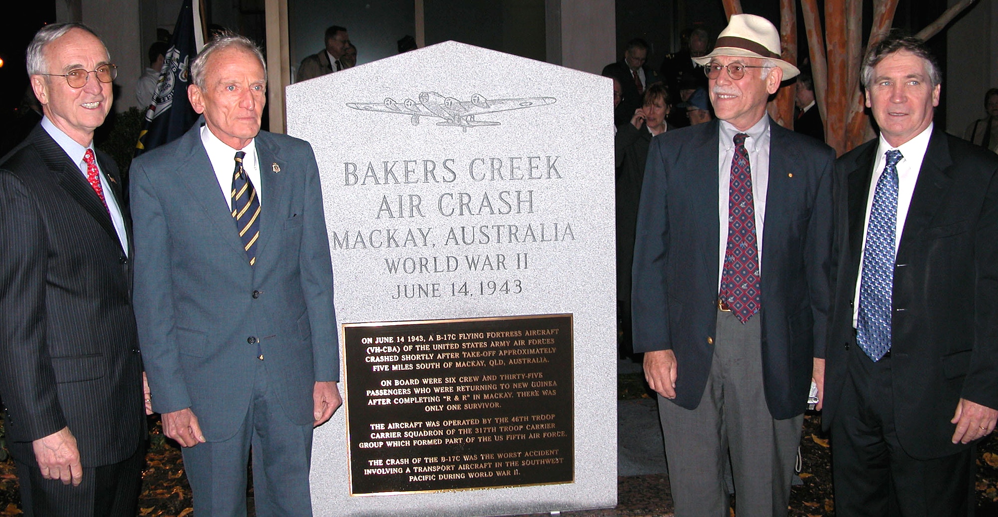 (Left to right) Deputy Defense Secretary Gordon England; Harry McAlpine, president of the Returned and Services League's Washington, D.C., sub-branch; Robert S. Cutler, executive director of the Bakers Creek Memorial Association; and Australian Ambassador to the United States Dennis Richardson stand next to the Bakers Creek air crash memorial on the Australian Embassy's grounds Nov. 8 in Washington, D.C. (DOD photo/Gerry J. Gilmore)