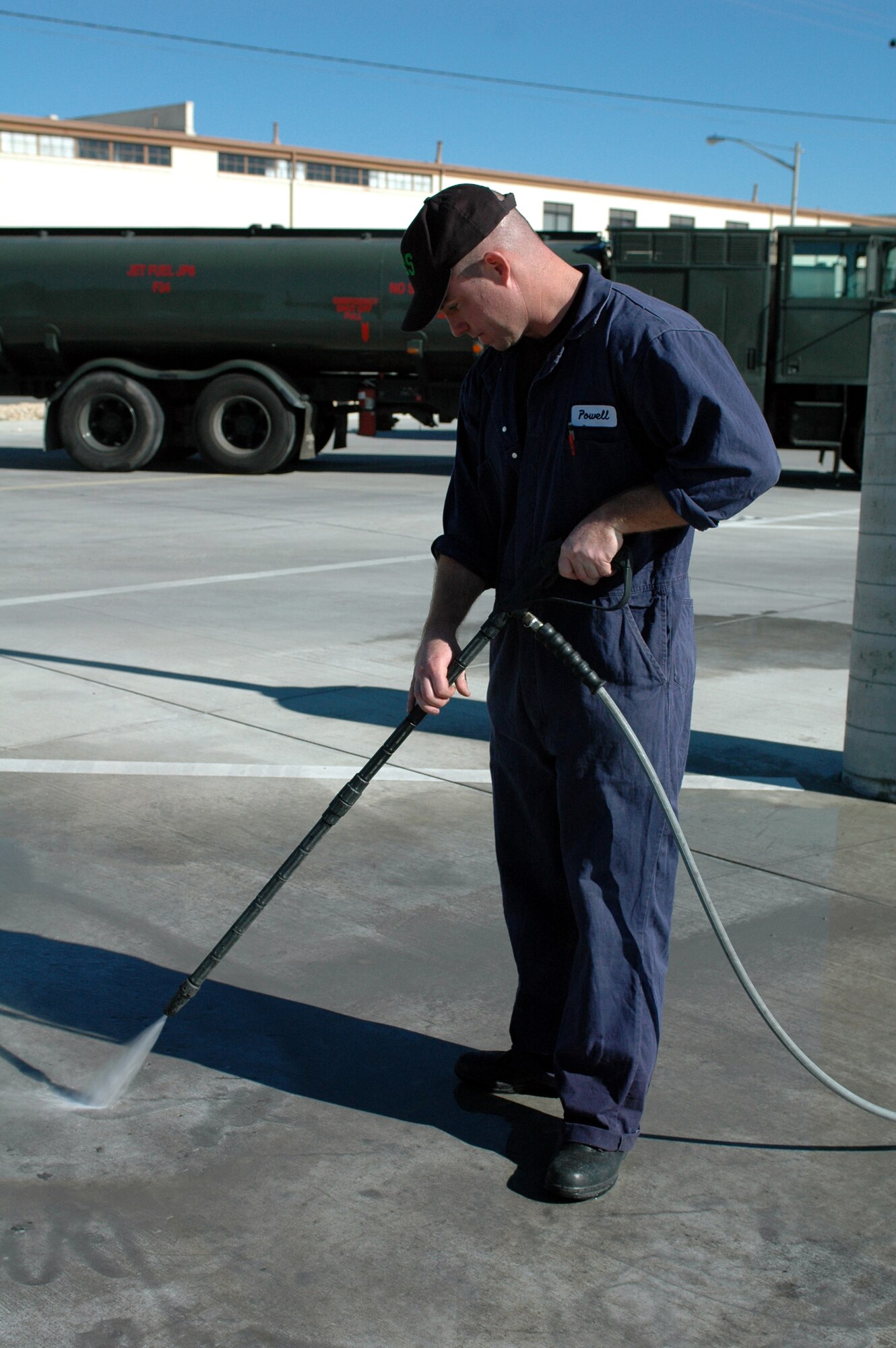 Staff Sgt. Shane Powell, 60th Logistics Readiness Squadron NCOIC of Preventive Maintenance, cleans fuel from of a yard pad. The 60th LRS Fuels Management Flight is competing for the William H. Penton Award, awarded to the best fuel operations unit in the Air Mobility Command. (U.S. Air Force photo by Tech. Sgt. Donald Osborn/ 60th Air Mobility Wing Public Affairs)